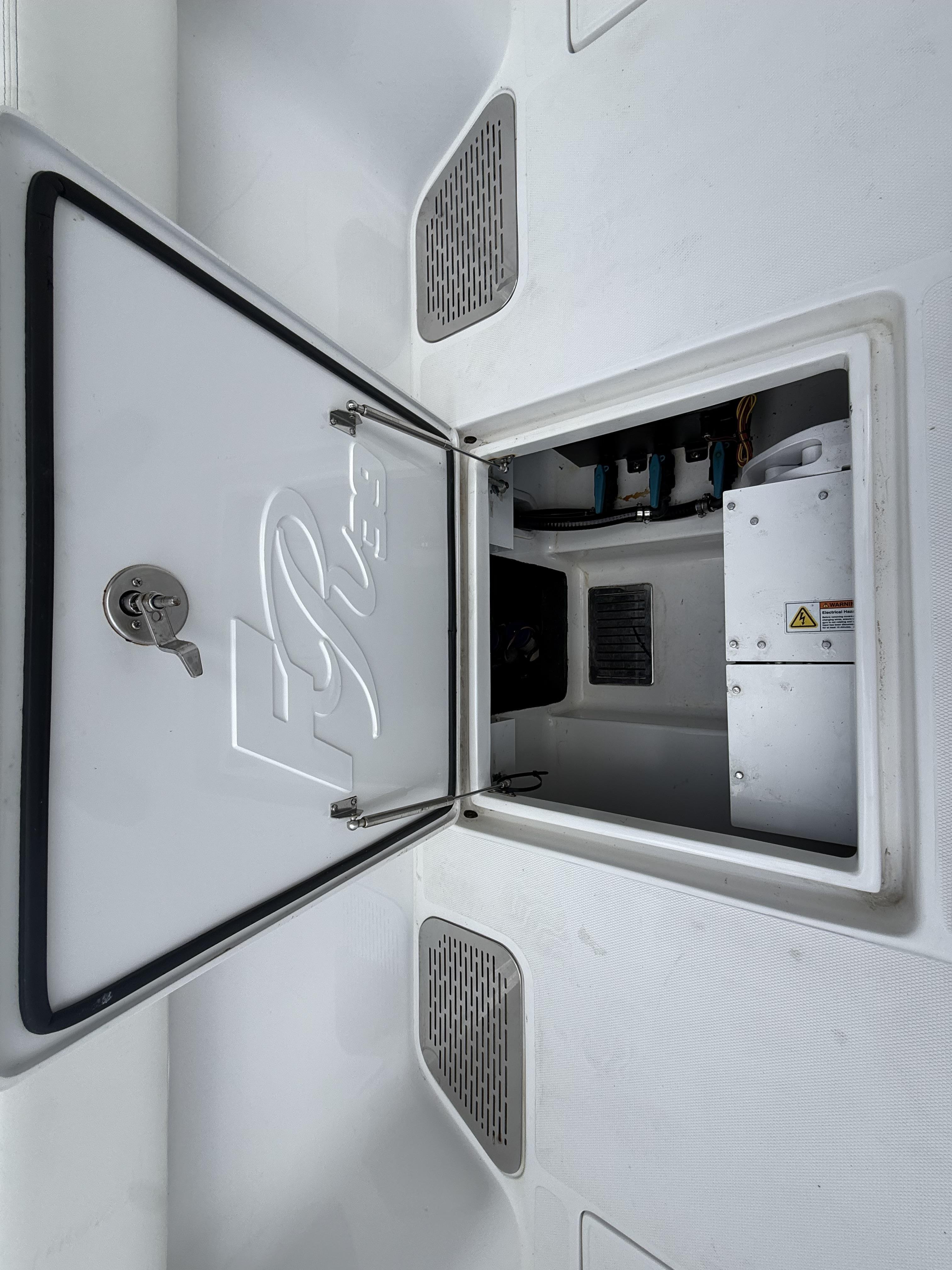 2024 Front Runner 39 CC boat storage compartment with open hatch and visible interior components.