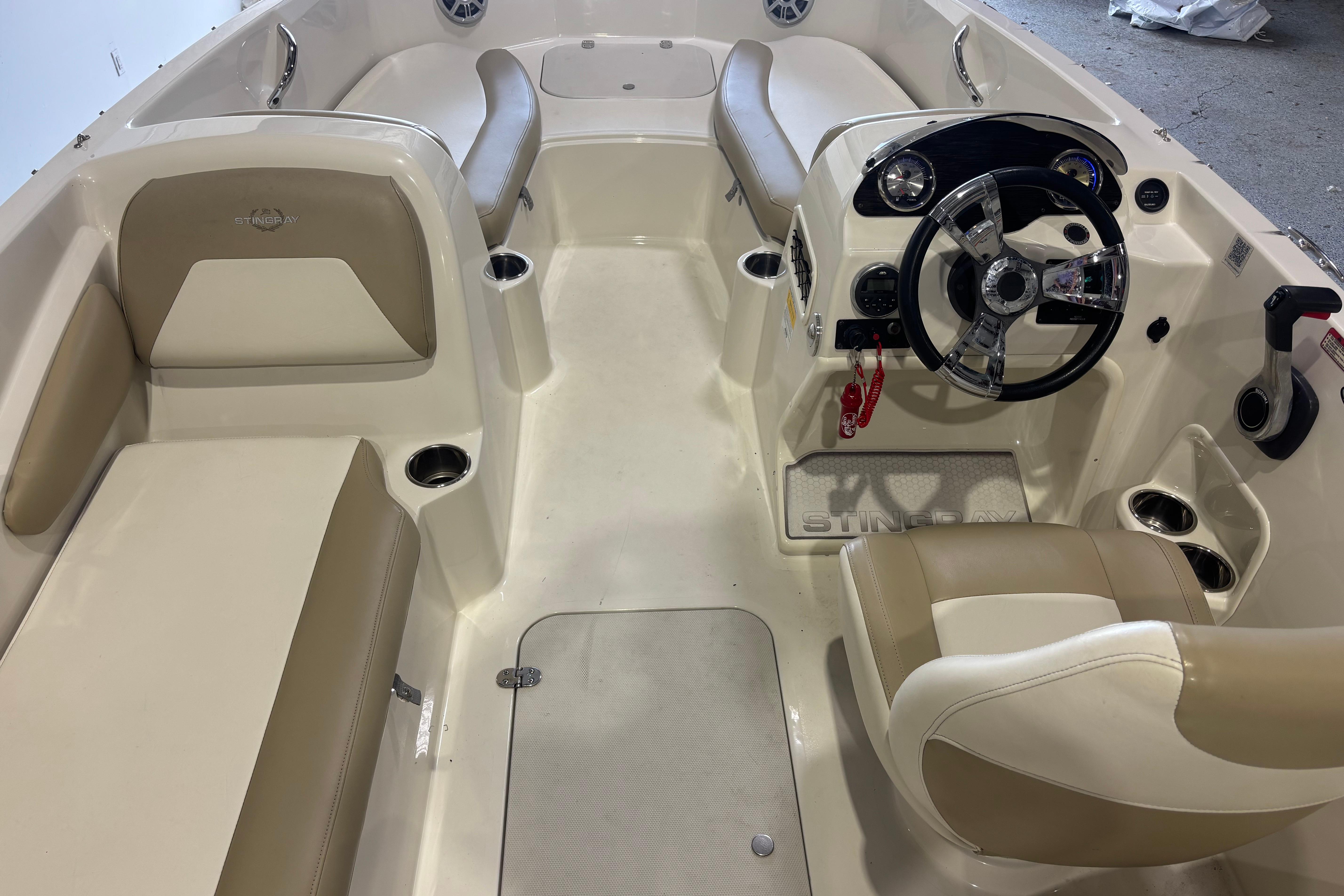 2017 Stingray 182 SC boat interior with beige seating and modern steering console.