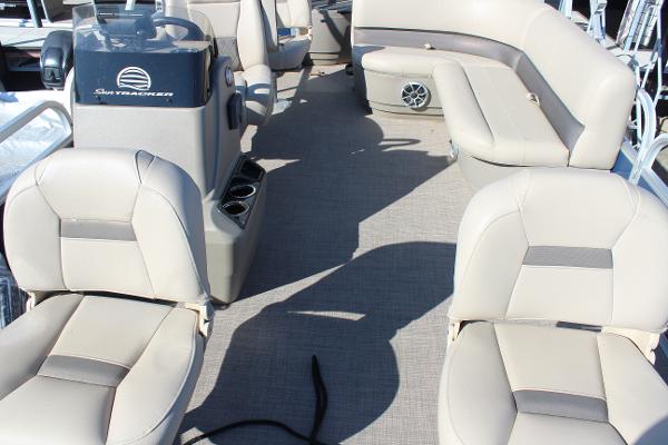 2024 Sun Tracker BB18 boat interior with beige seating and steering console.