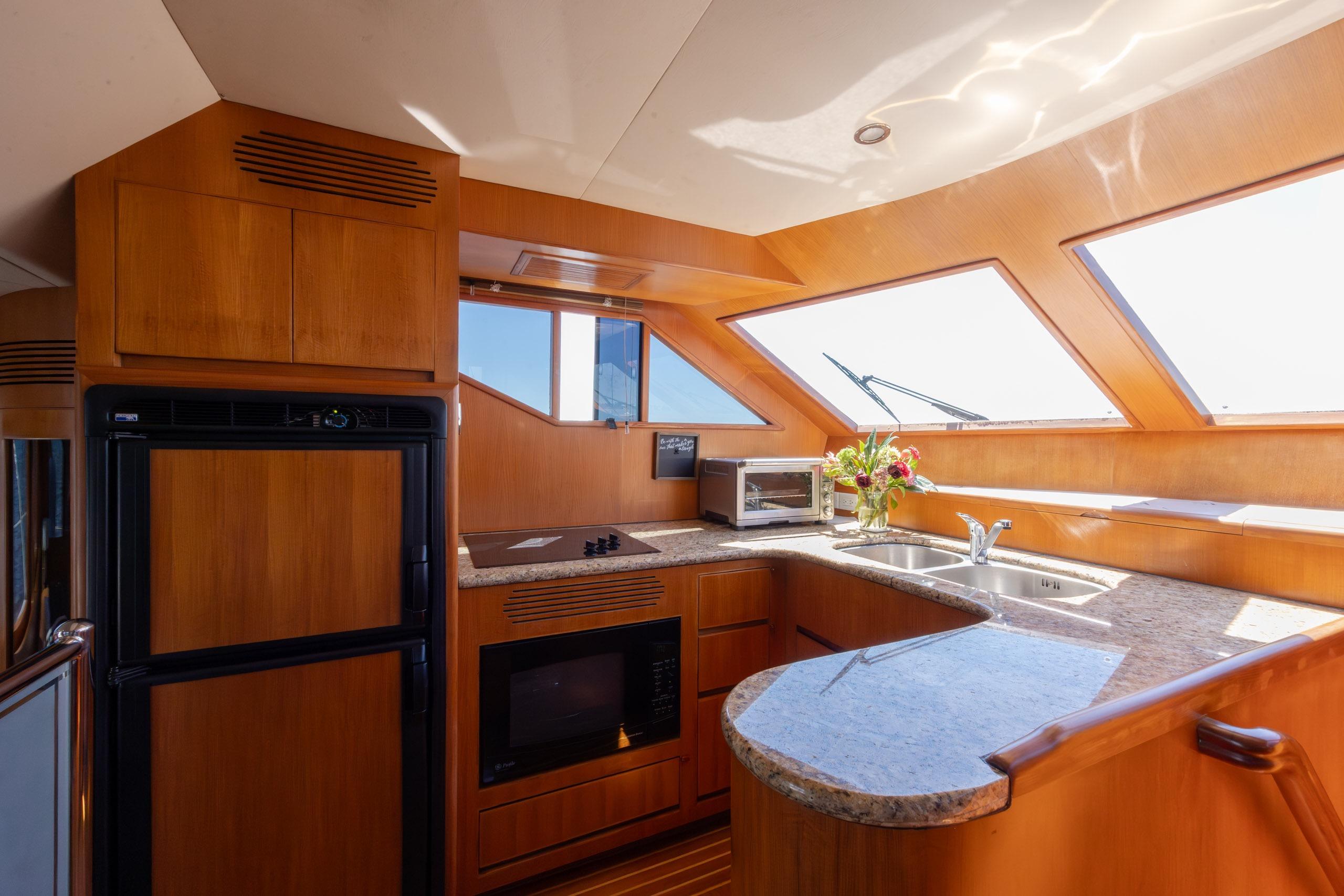Luxurious kitchen interior of 2005 Ocean Alexander 52 Sedan yacht with modern amenities.