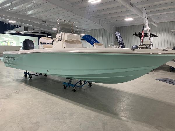 2026 Robalo 226 Cayman boat displayed indoors, mint green hull, sleek design.