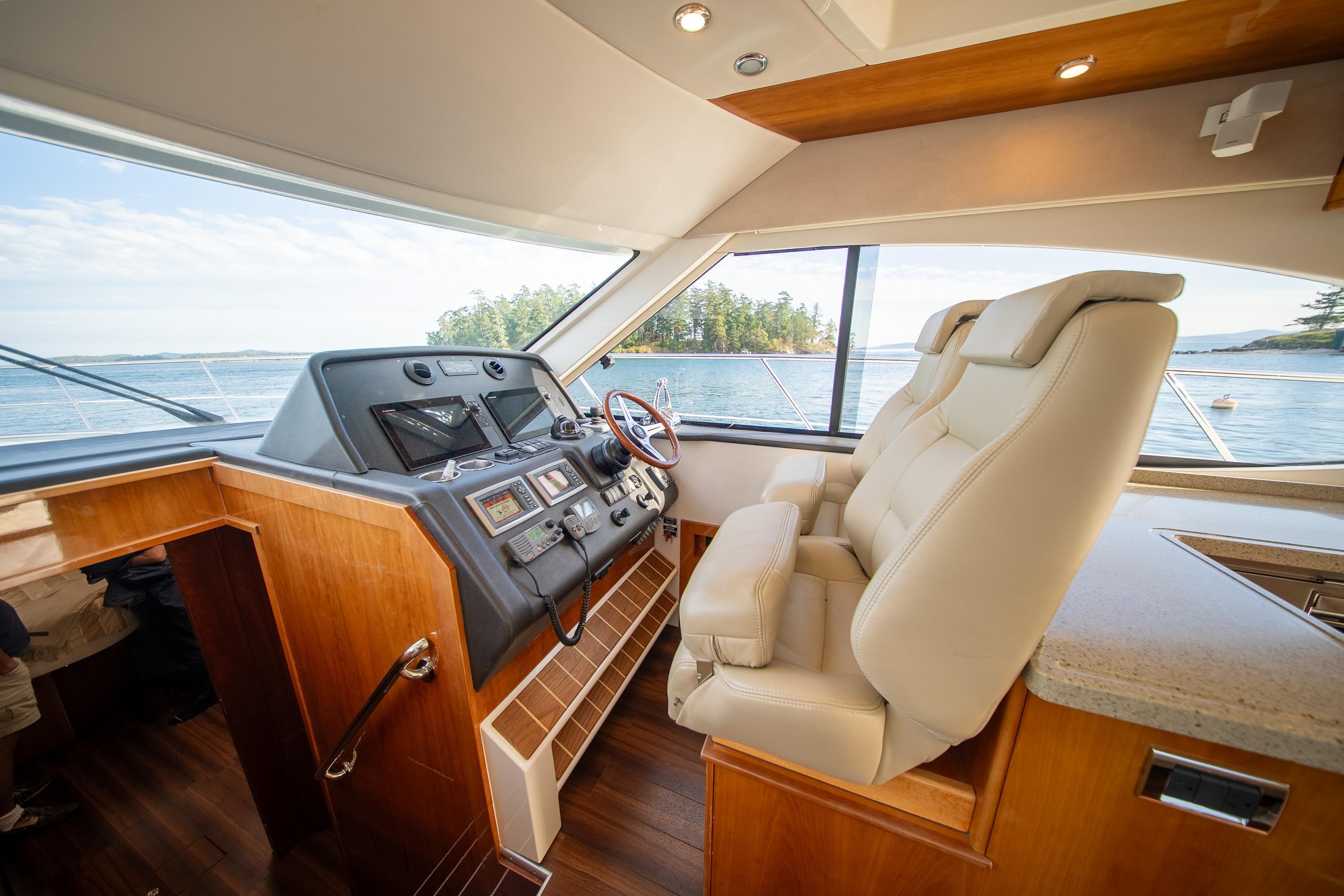 Interior of 2011 Riviera 5000 Sport Yacht with luxurious helm and ocean view.