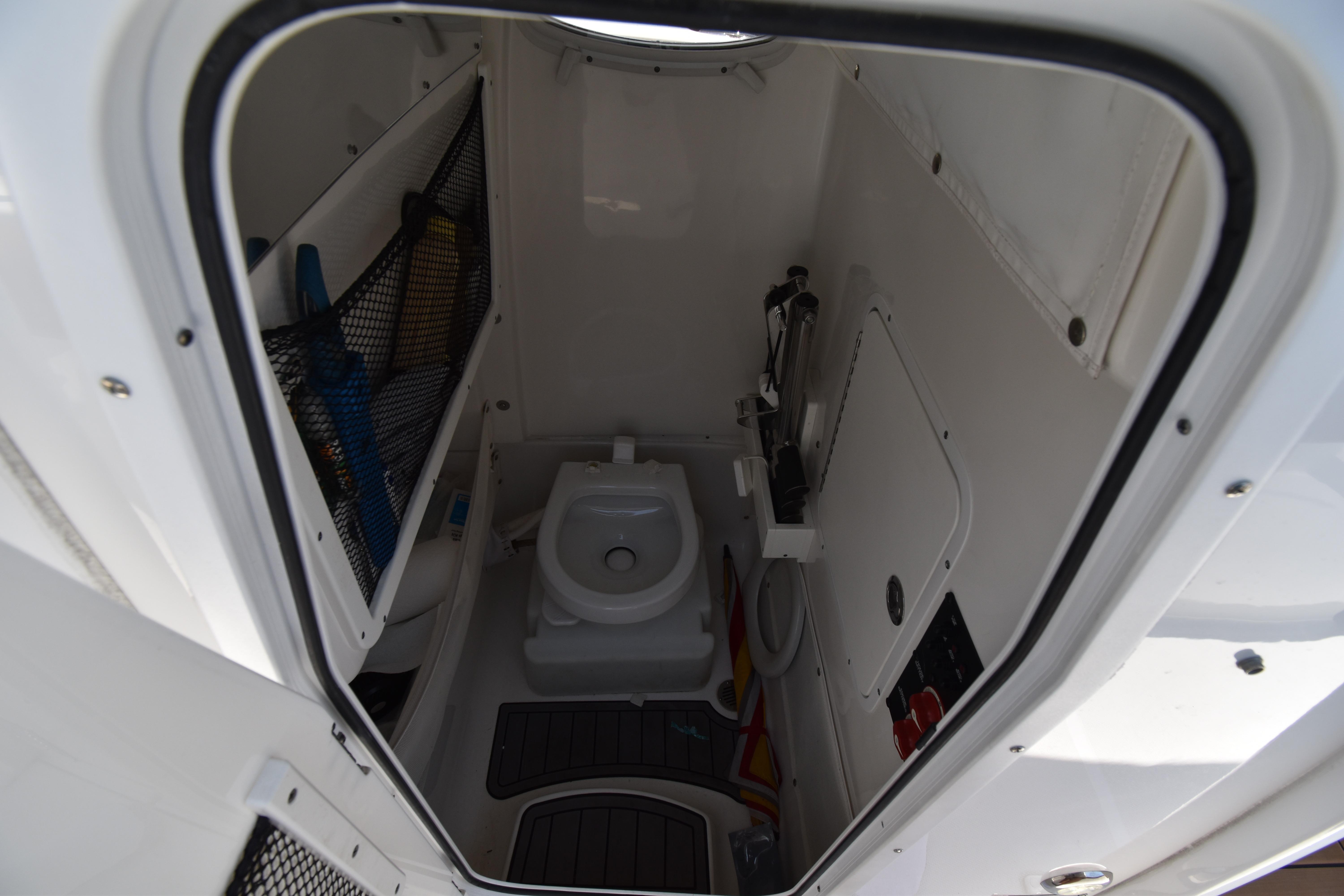 Interior view of 2020 Sea Hunt Ultra 275 SE boat's compact bathroom.
