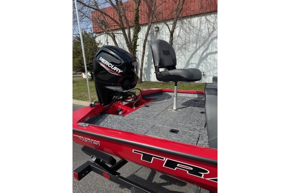 2026 Tracker Pro Team 175 boat with Mercury engine and seating, parked outdoors.