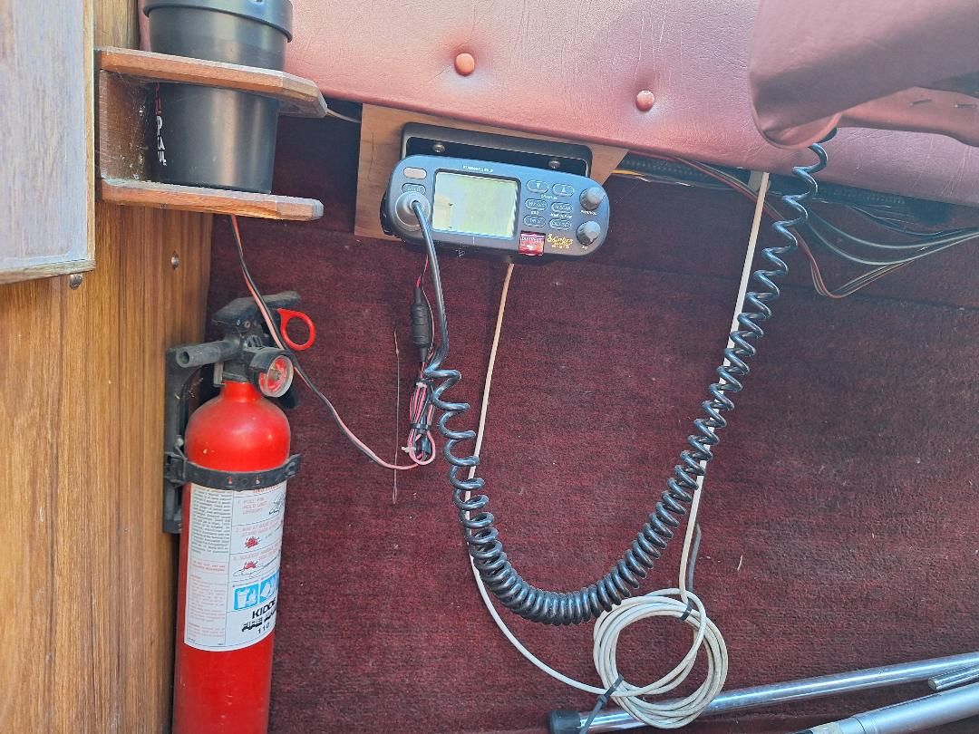 Interior of 1986 Sea Ray Weekender 230 with fire extinguisher and radio.