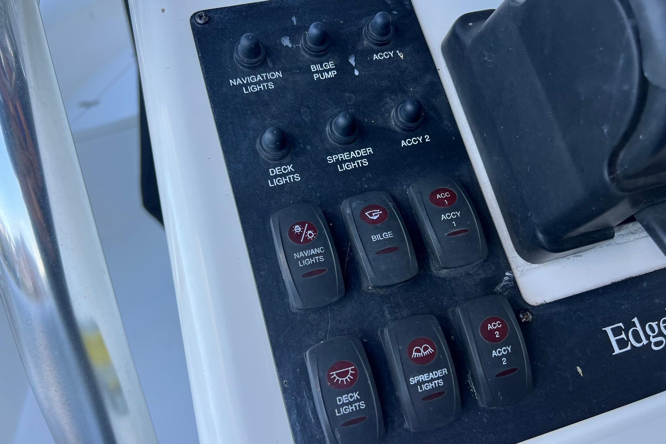 Control panel of a 2006 Edgewater 245CC boat with various switches and labels.