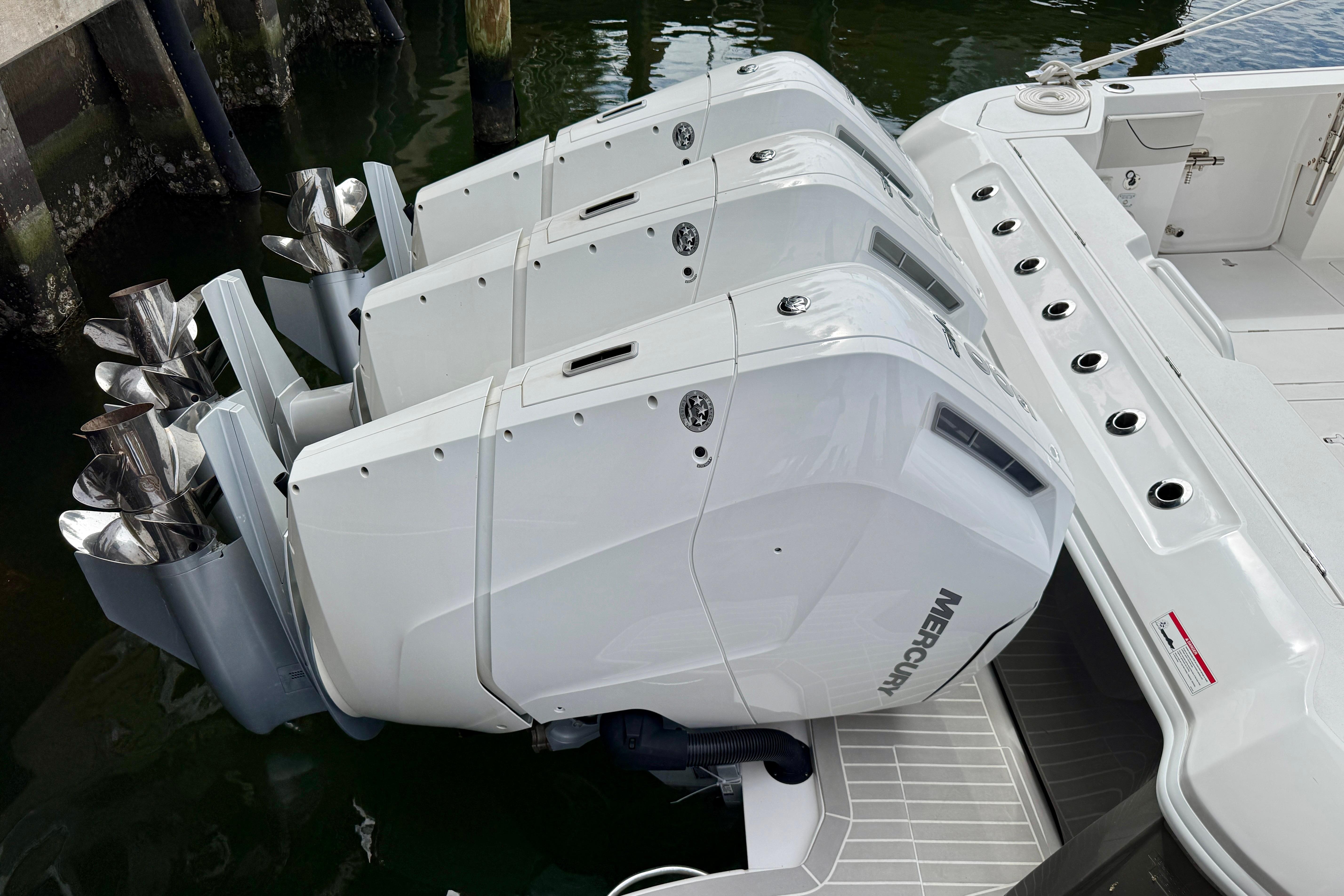 2024 Intrepid 427 Nomad SE with triple Mercury outboard engines docked.