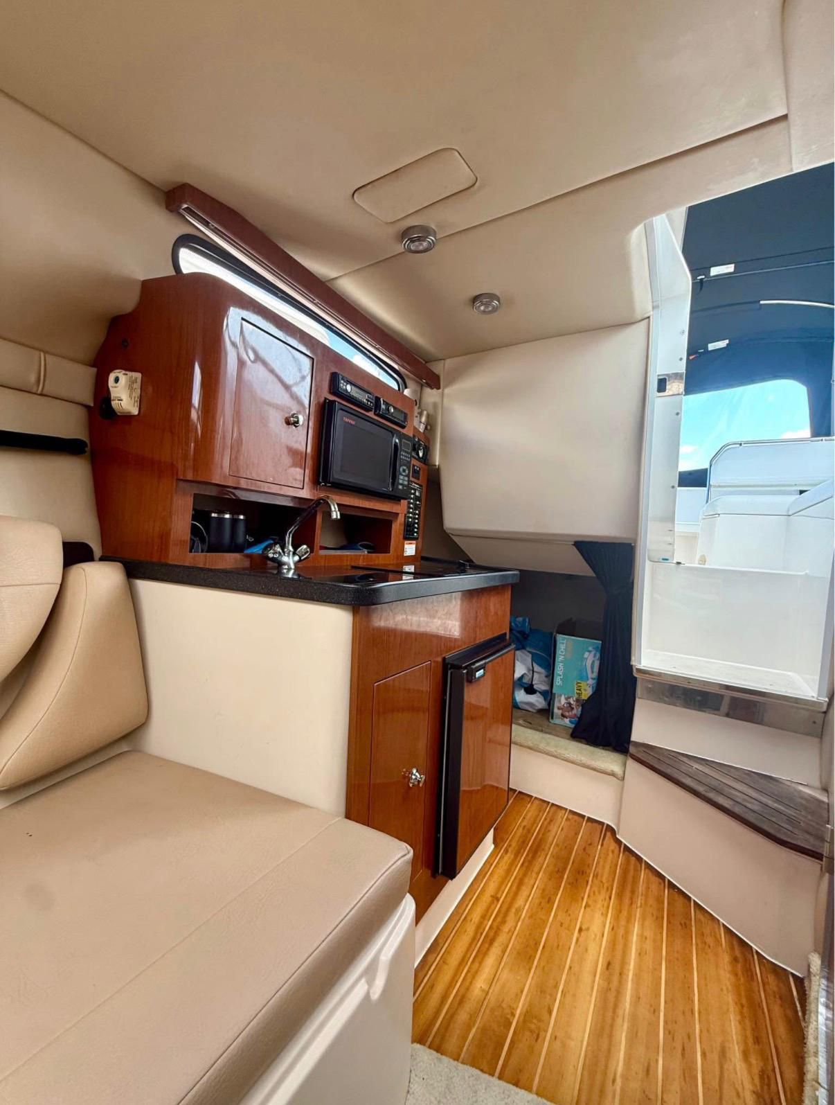 Interior of the 2008 Regal 2565 Window Express with kitchenette and seating area.