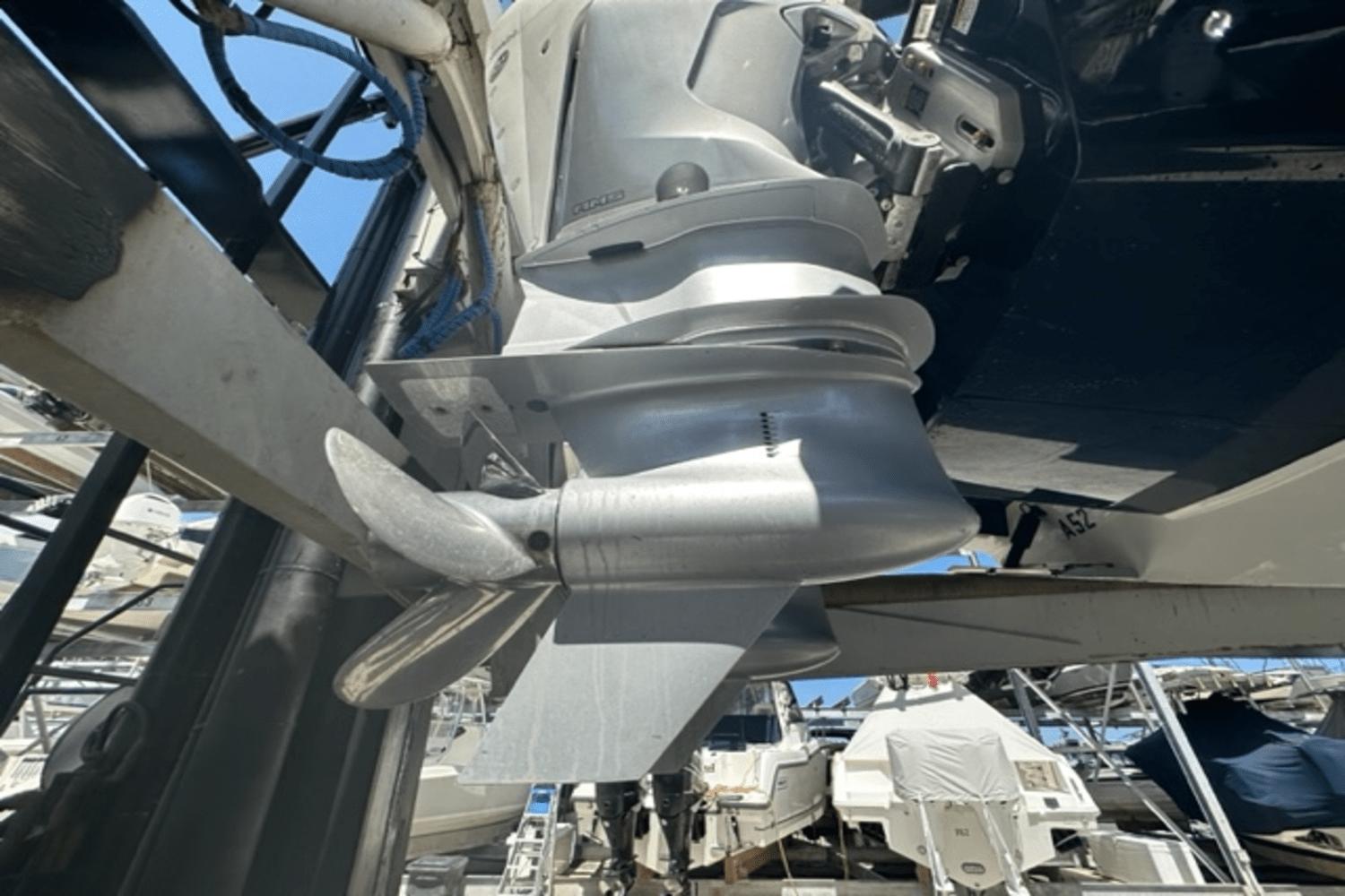 Close-up of 2022 Aviara AV32 Outboard motor and propeller in a marina.