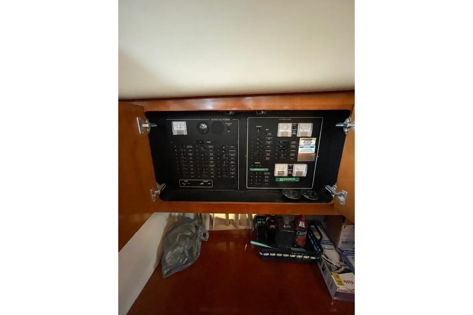 Electrical panel inside a 2003 Carver 36 Super Sport boat, featuring switches and circuit breakers.
