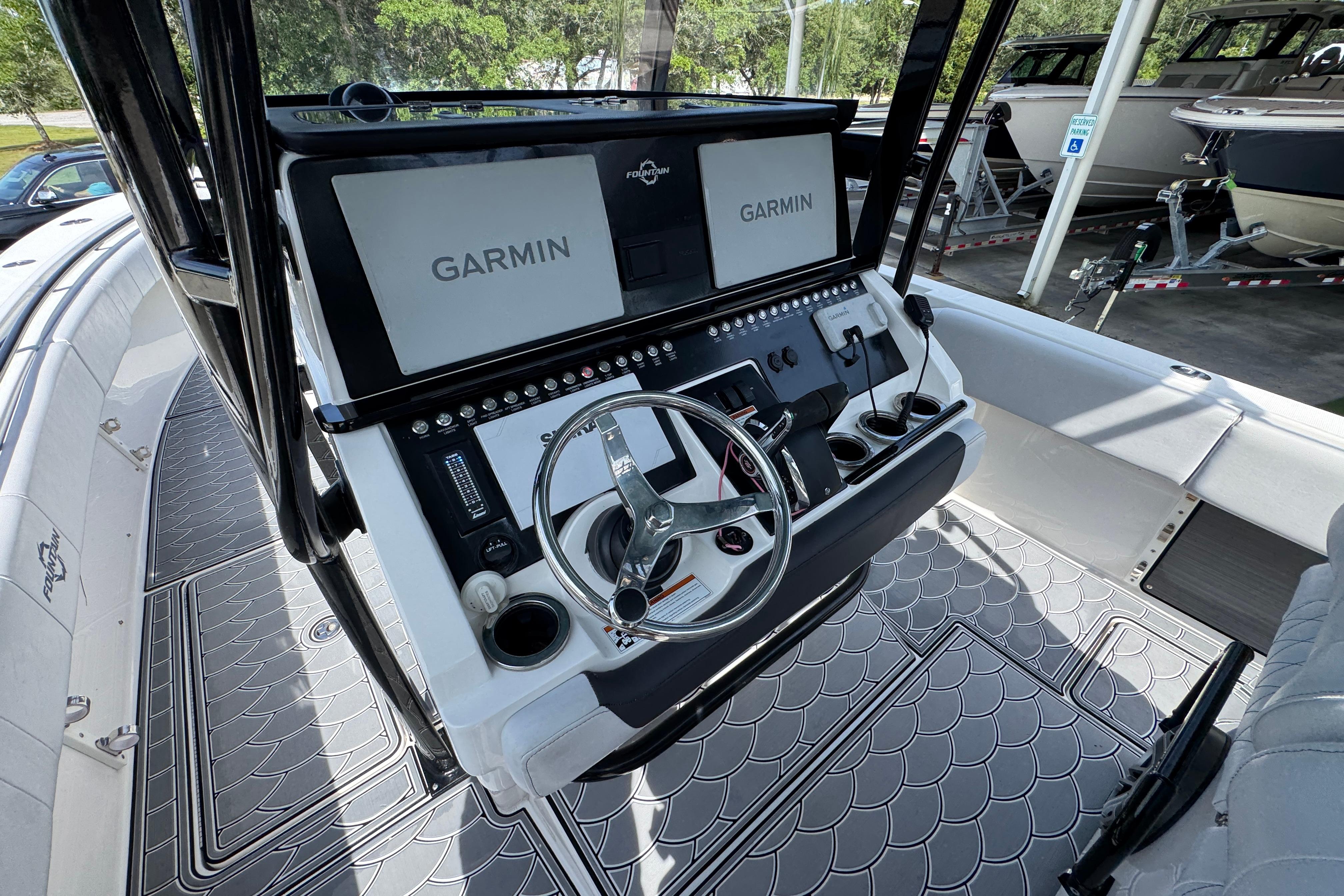 2023 Fountain 34 Tournament Edition boat cockpit with Garmin displays and modern steering wheel.