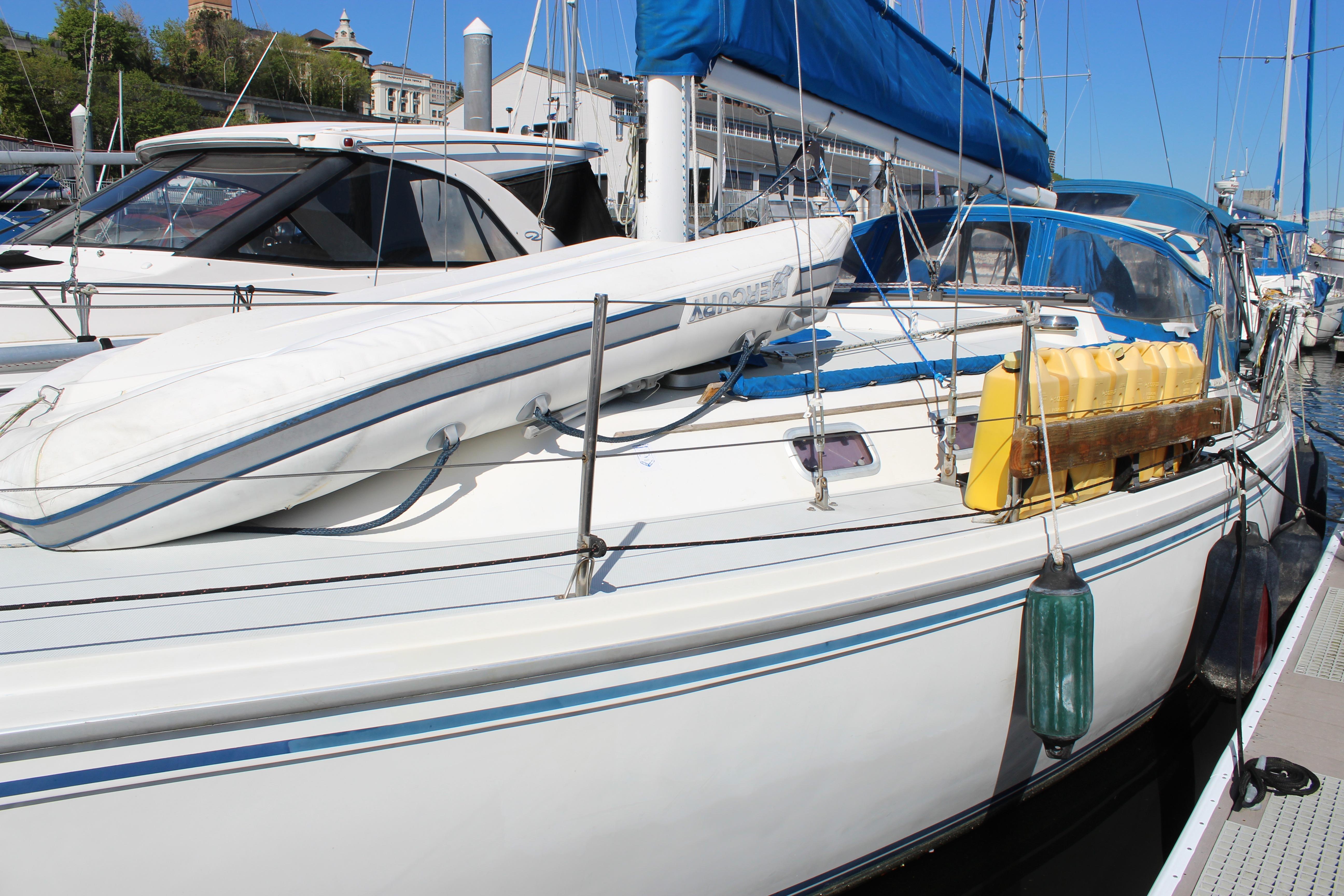 Catalina 36 MkII 1991 sailboat docked with blue cover and equipment on deck.