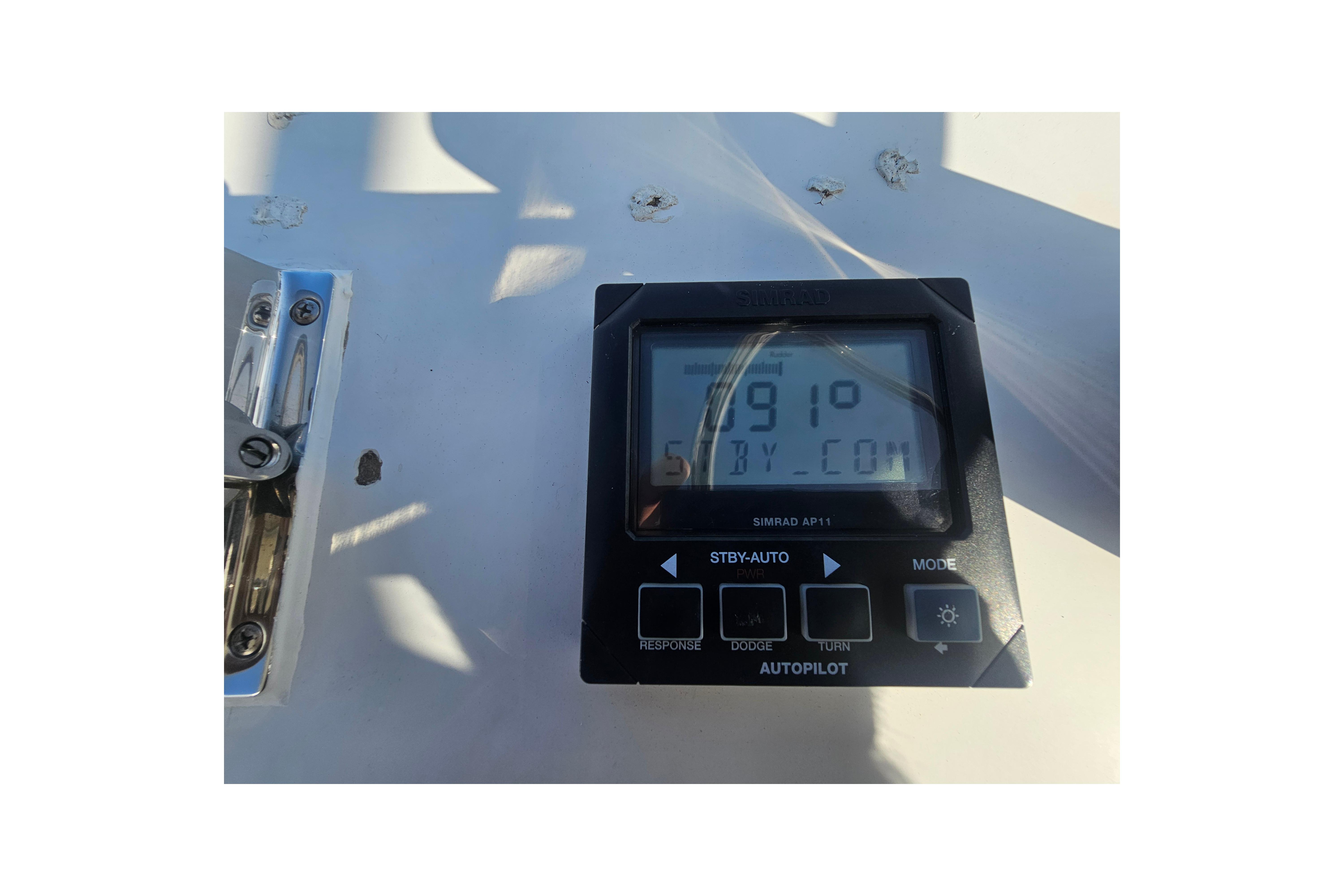 Simrad AP11 autopilot display on 2003 Topaz 32 Express boat dashboard.