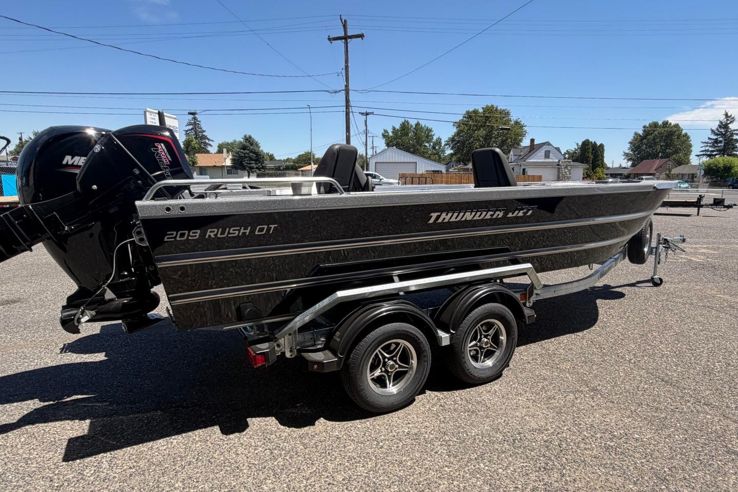2026 Thunder Jet 209 Rush OT boat on trailer, parked outdoors under clear sky.
