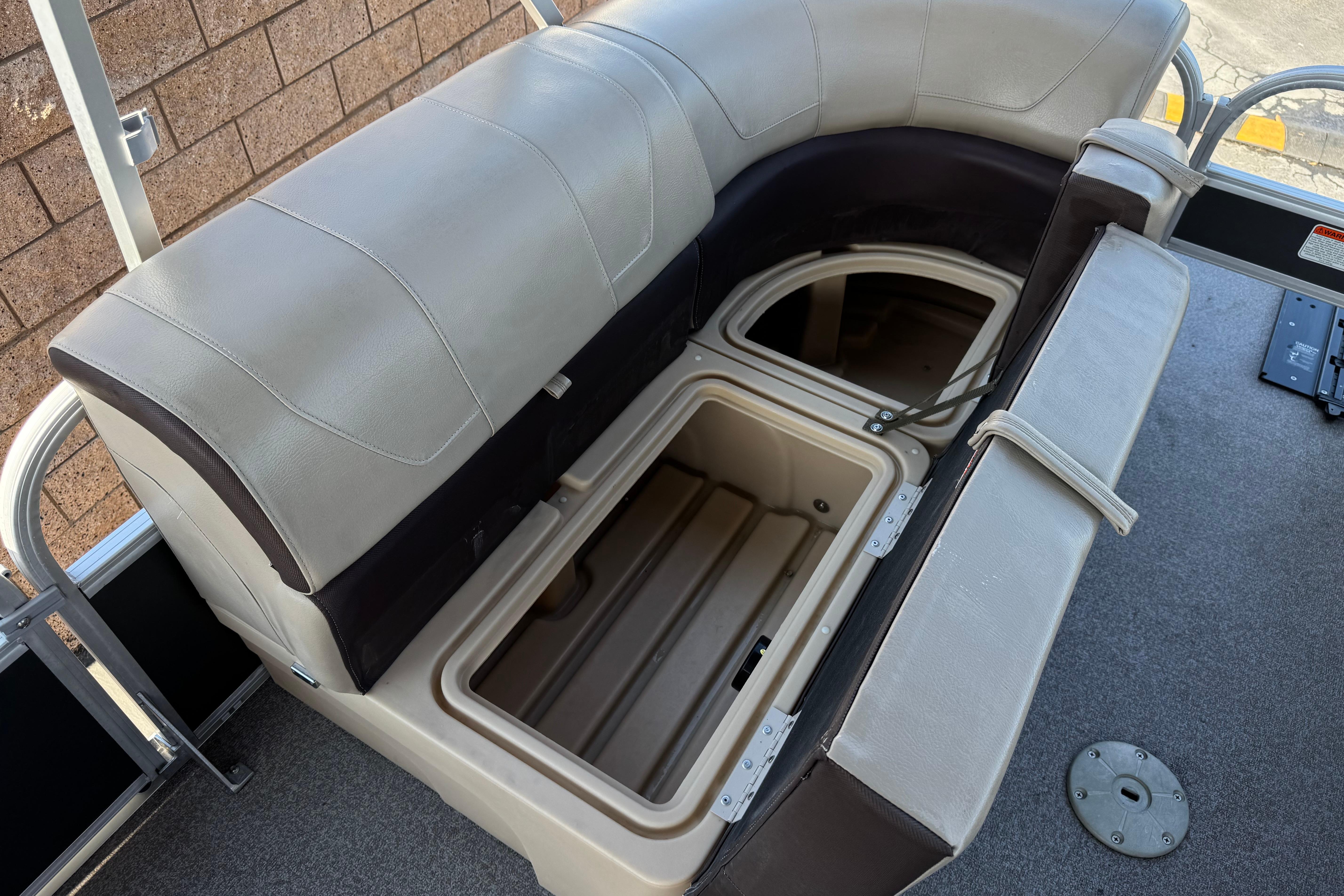 2018 Sun Tracker SportFish 22 DLX boat seat with open storage compartment.