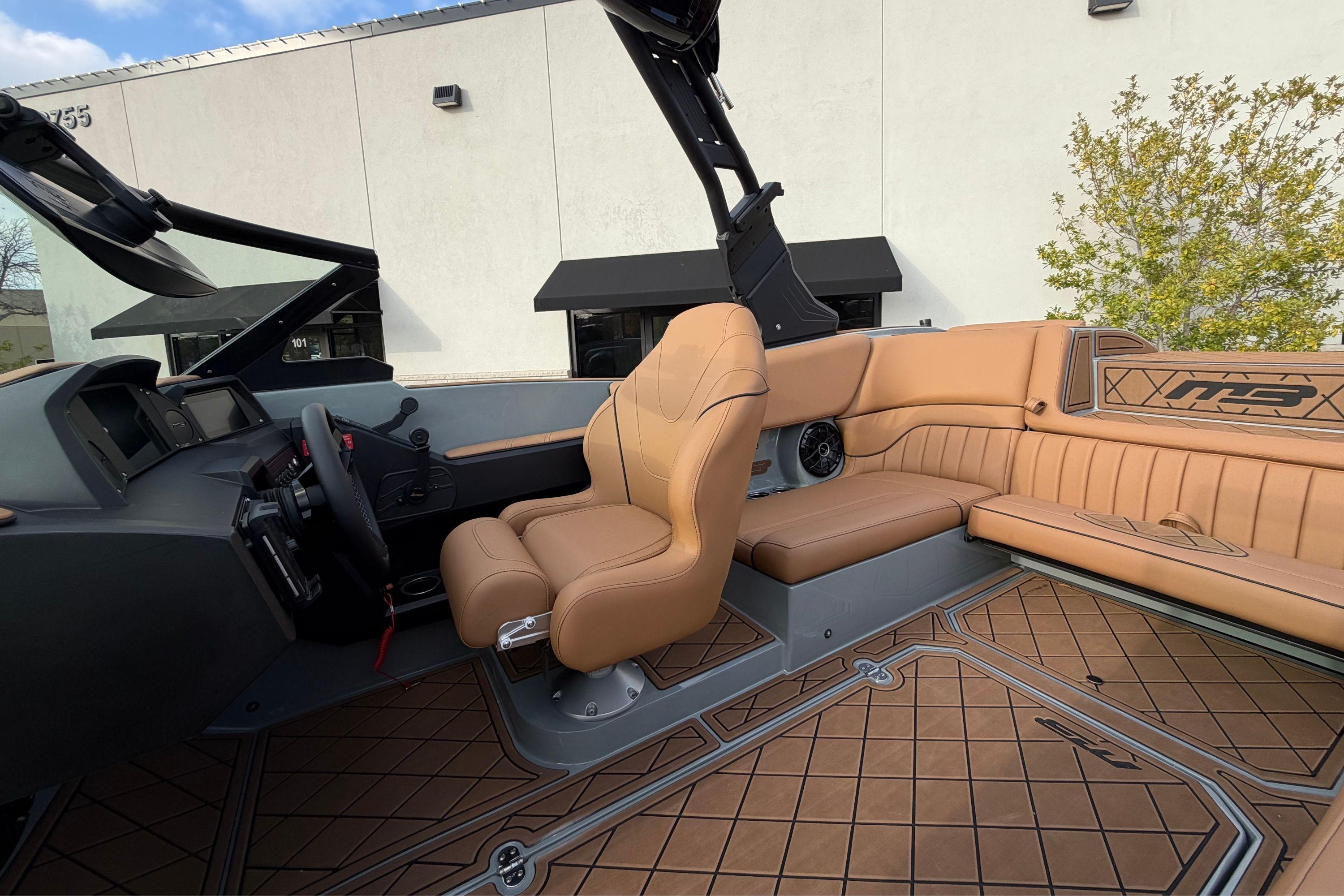 2026 MB B52 21 Alpha boat interior with tan leather seats and modern dashboard.
