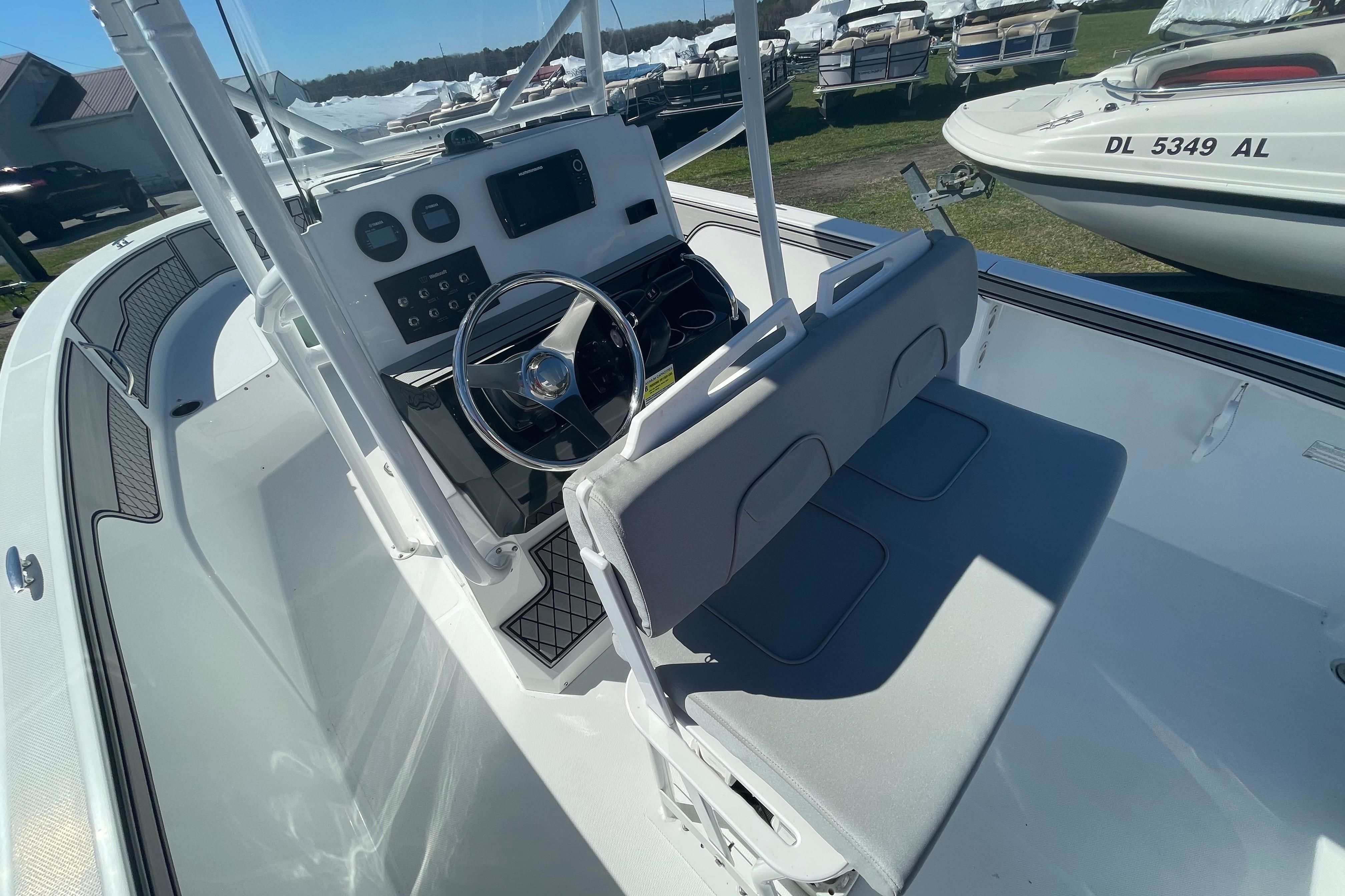 2022 Wellcraft 202 Fisherman boat interior with steering console and seating.