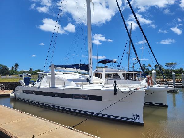 2009 Catana 65 catamaran docked at a marina under a clear blue sky.