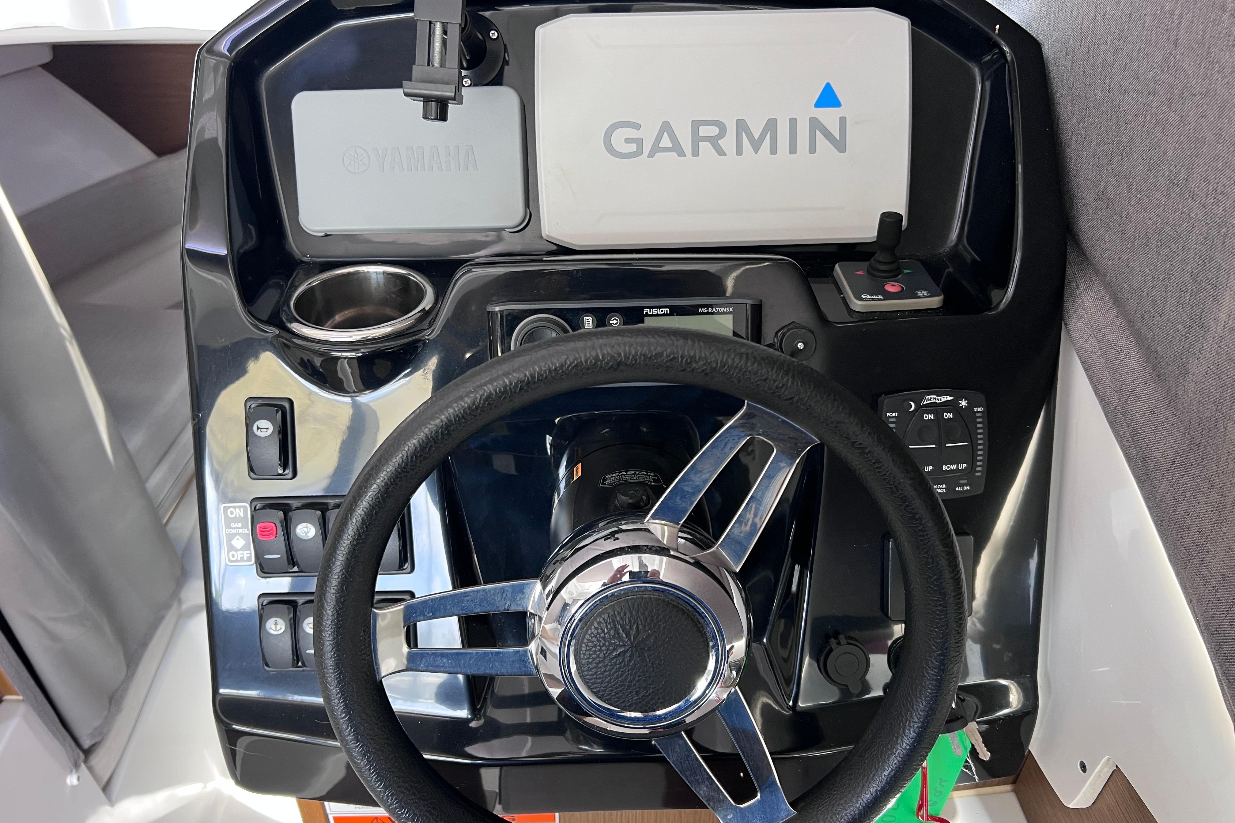Steering console of 2021 Jeanneau NC Weekender 795 Series 2 with Garmin navigation system.