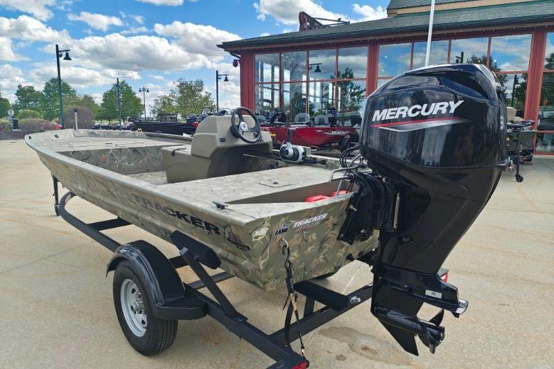 2025 Tracker Grizzly 1648 SC boat with Mercury engine on trailer, outdoors.