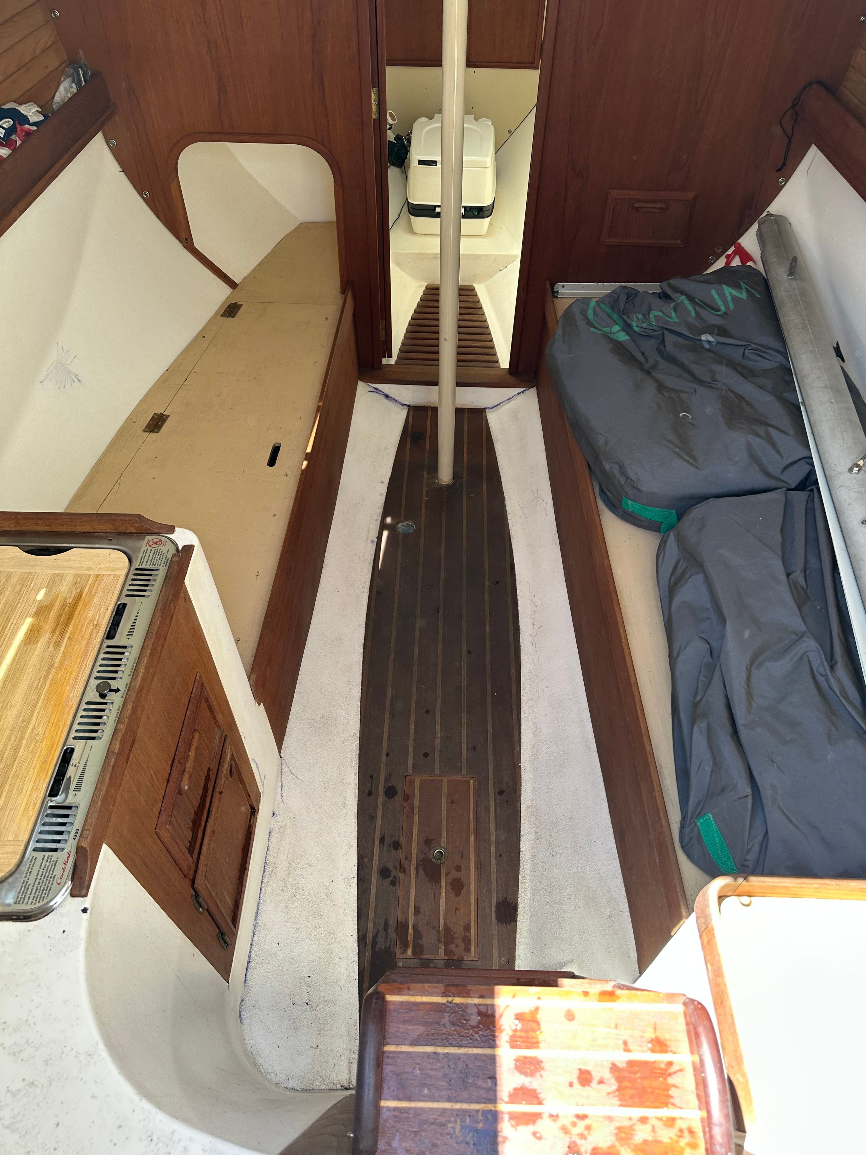 Interior view of a 1985 Cape Dory 25D with wooden flooring and seating areas.