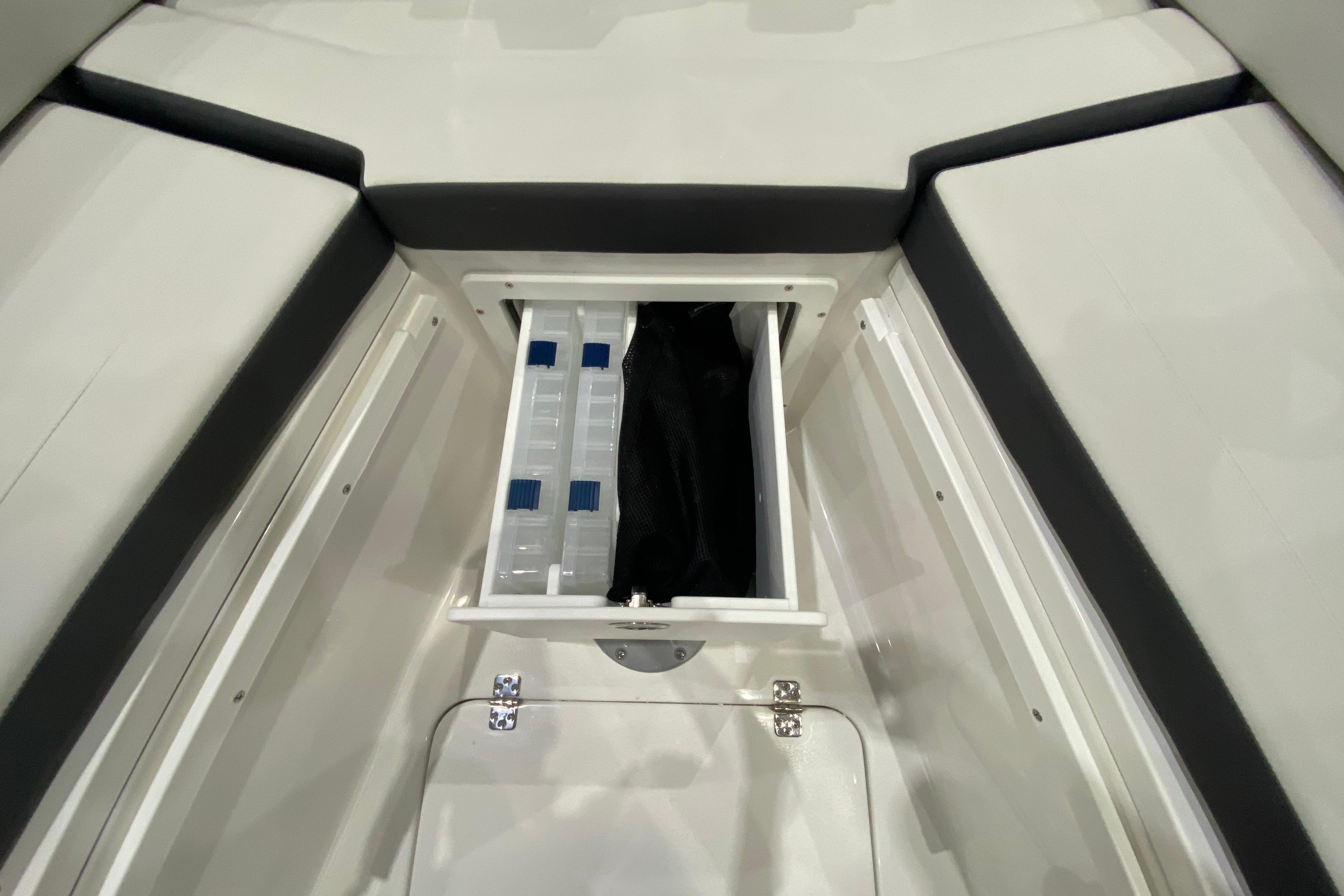 Storage compartment of 2027 Sea Pro 245FLXR Sandbar boat, featuring organized interior space.