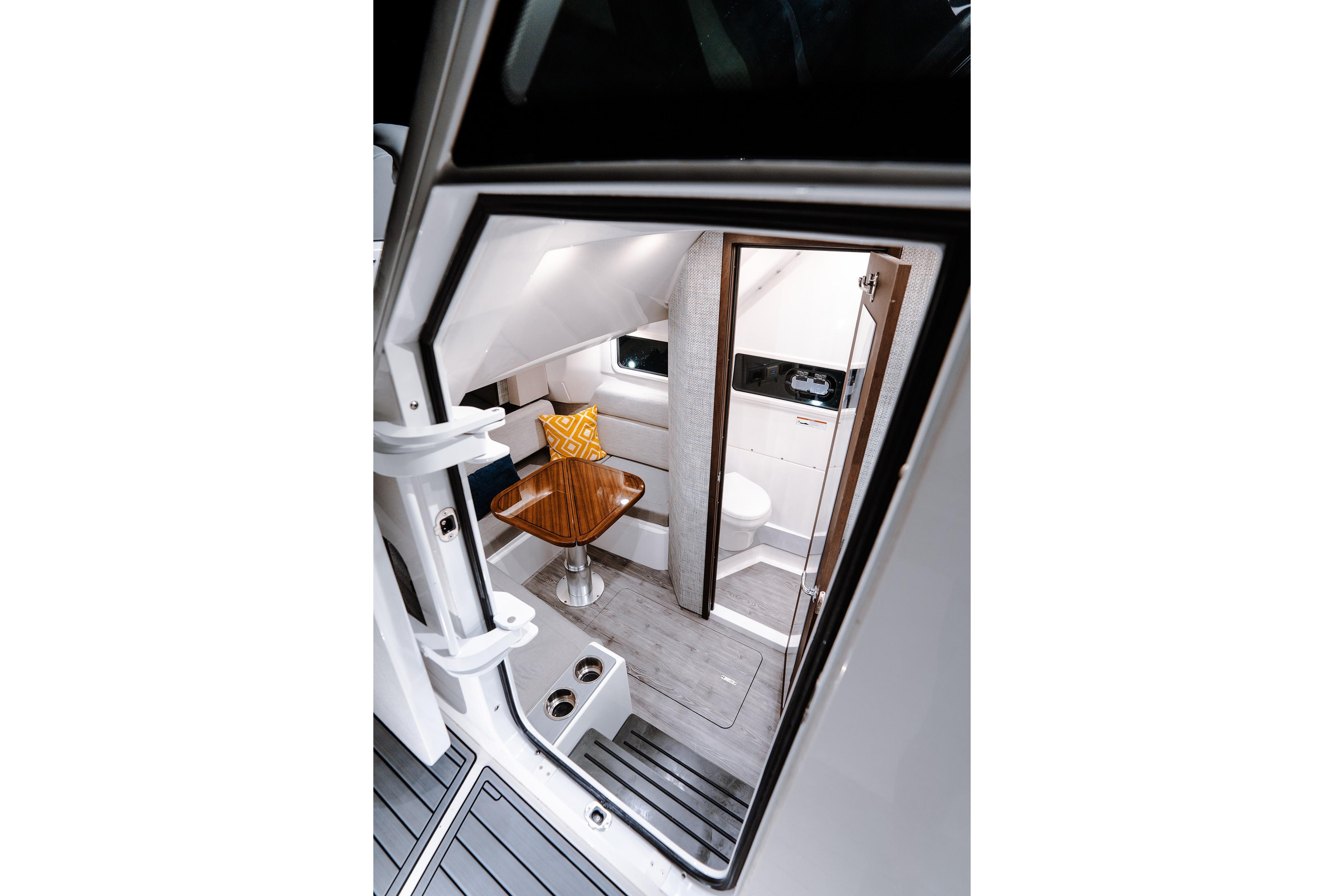 Interior view of 2026 Everglades 455 Center Console boat, featuring a cozy cabin space.