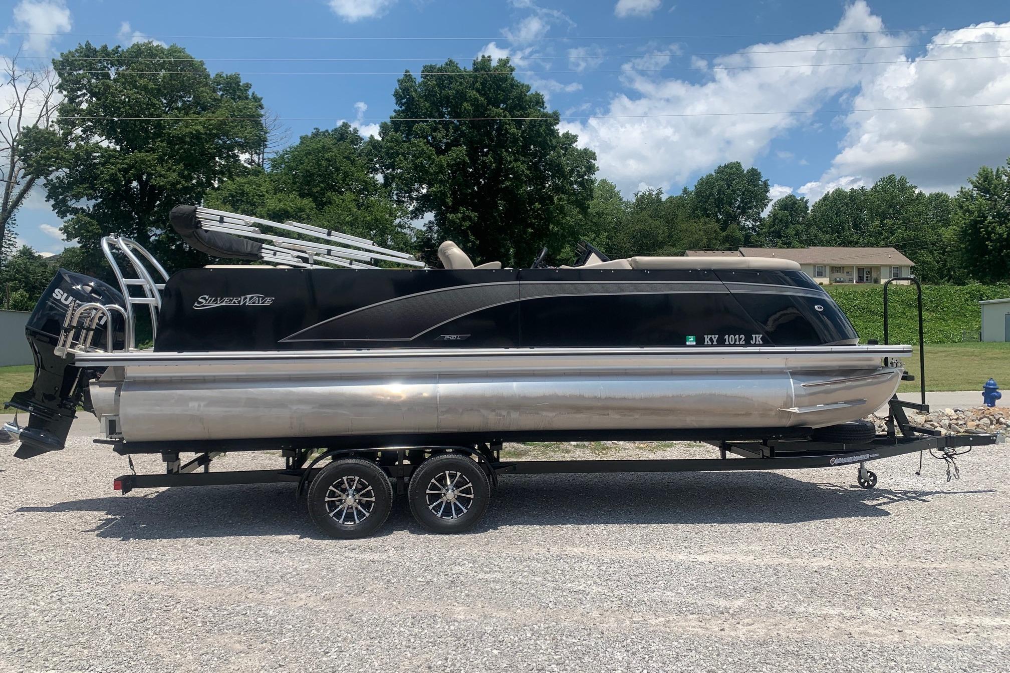 2023 Silver Wave 2410 SW3 CLS pontoon boat on trailer, parked outdoors.