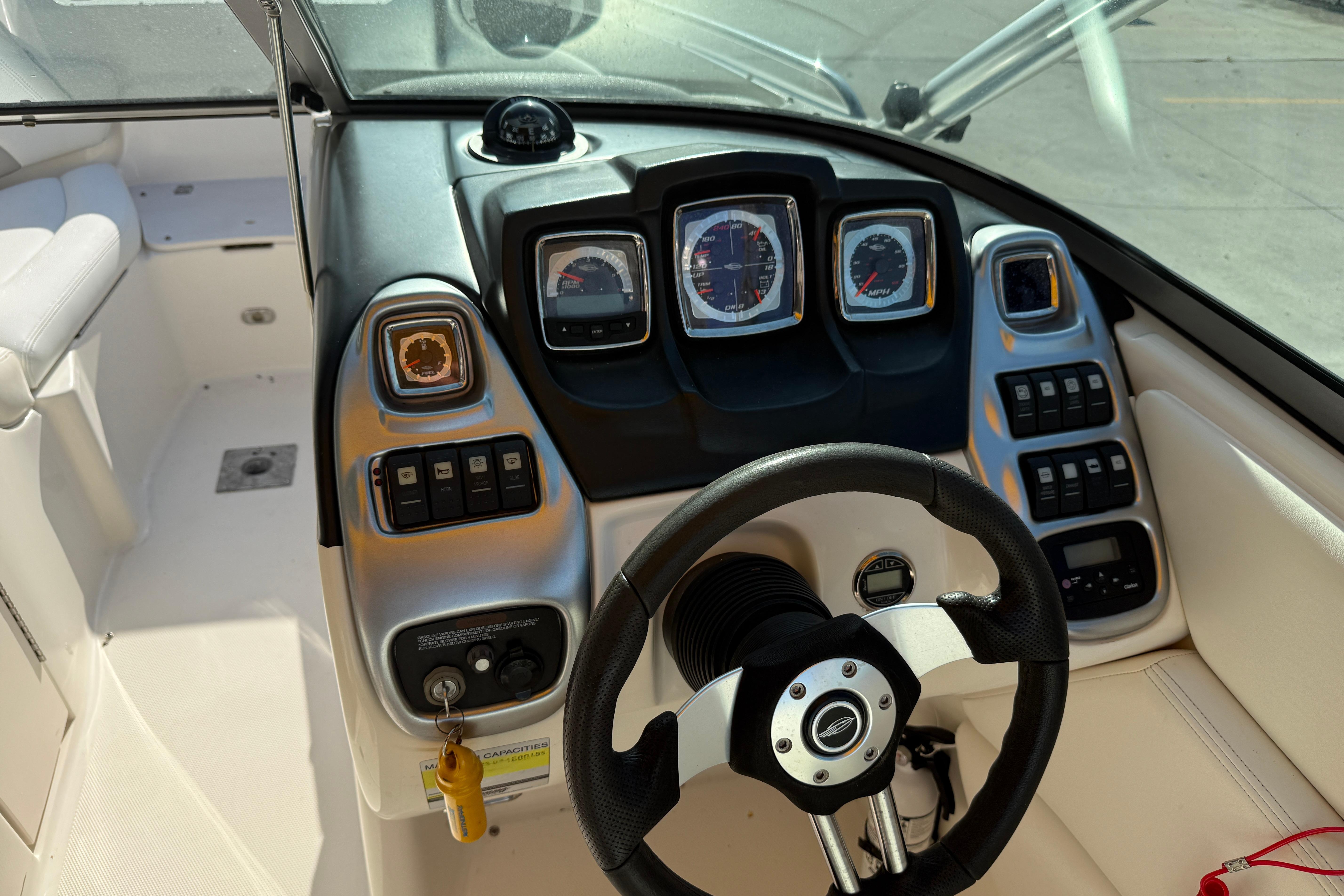 2008 Chaparral 236 SSX boat dashboard with steering wheel and instrument panel.