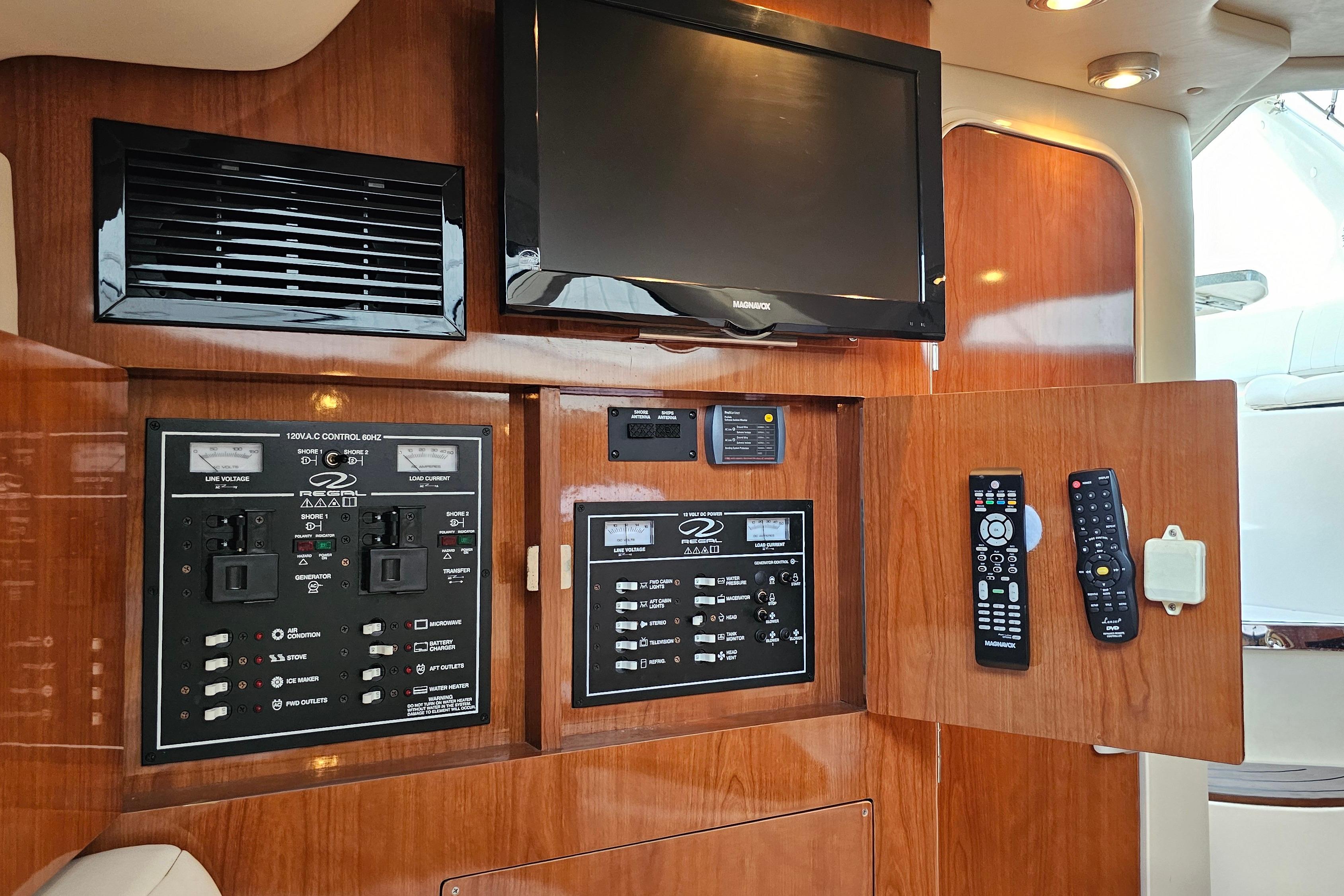 2005 Regal 3060 Window Express interior with control panels and TV setup.