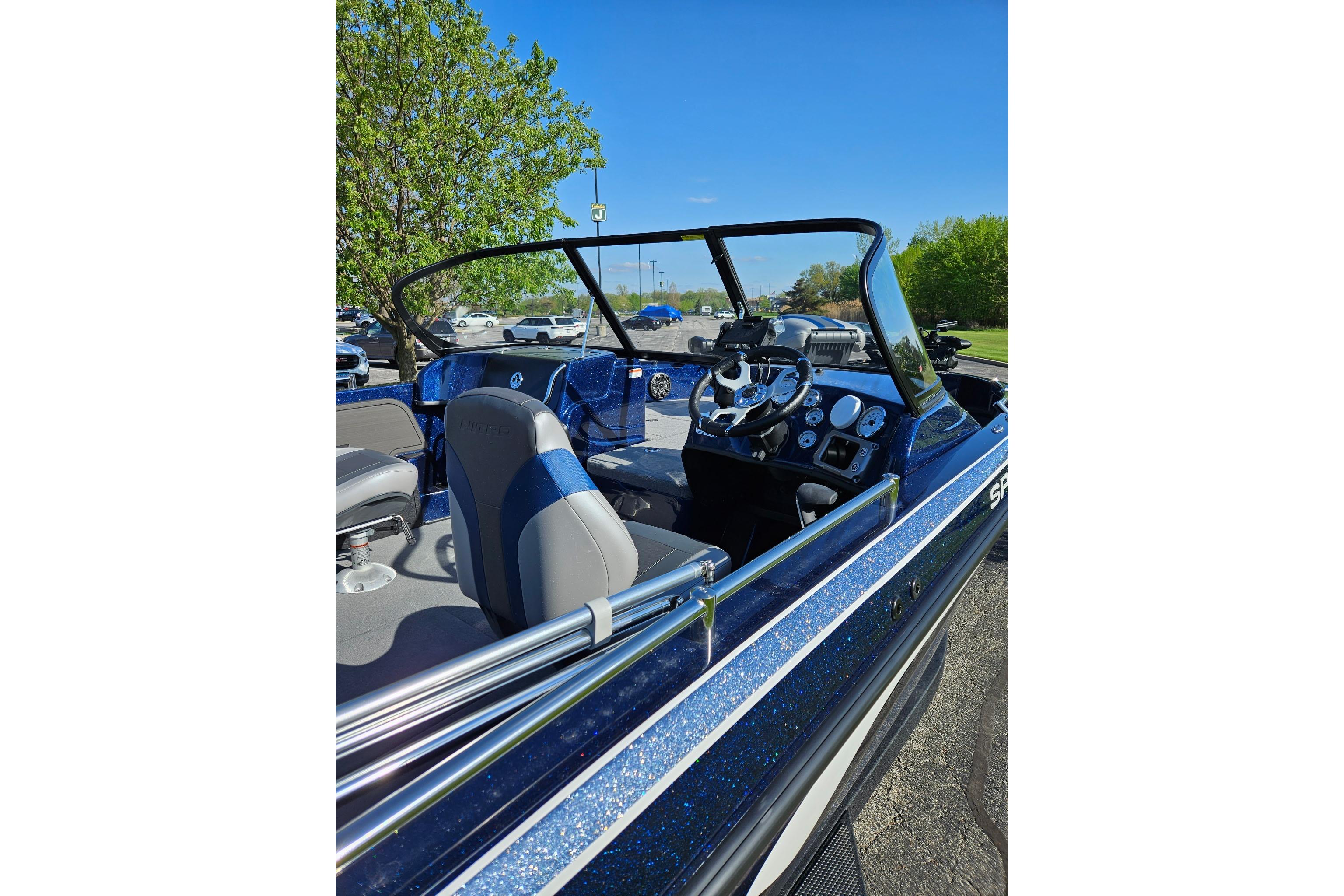 2026 Nitro ZV19 Sport Pro boat interior with steering wheel and dashboard, parked outdoors.