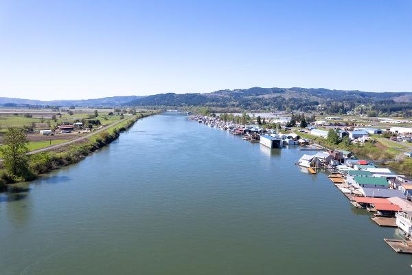 Aerial view of a river with boathouses, including a 1985 Custom Larson Boathouse.
