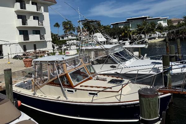 1978 Dyer 29 Trunk Cabin boat docked at a marina under clear skies.