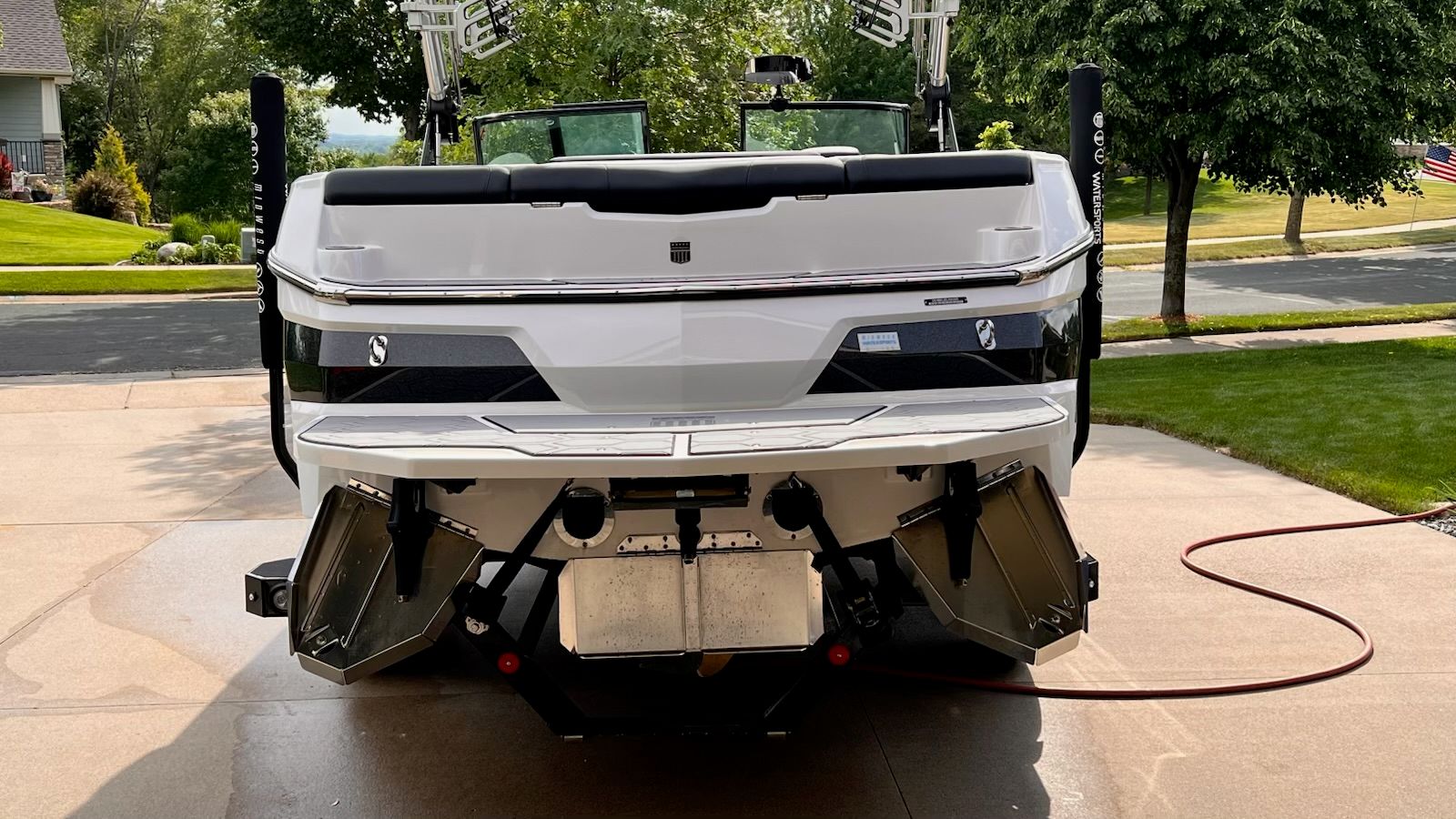 The image shows the rear of a white 2020 MasterCraft NXT22 boat on a driveway.
