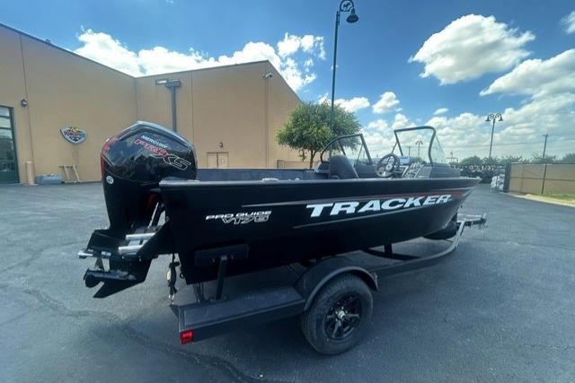 2026 Tracker Pro Guide V-175 Combo boat on trailer, parked outdoors under a cloudy sky.