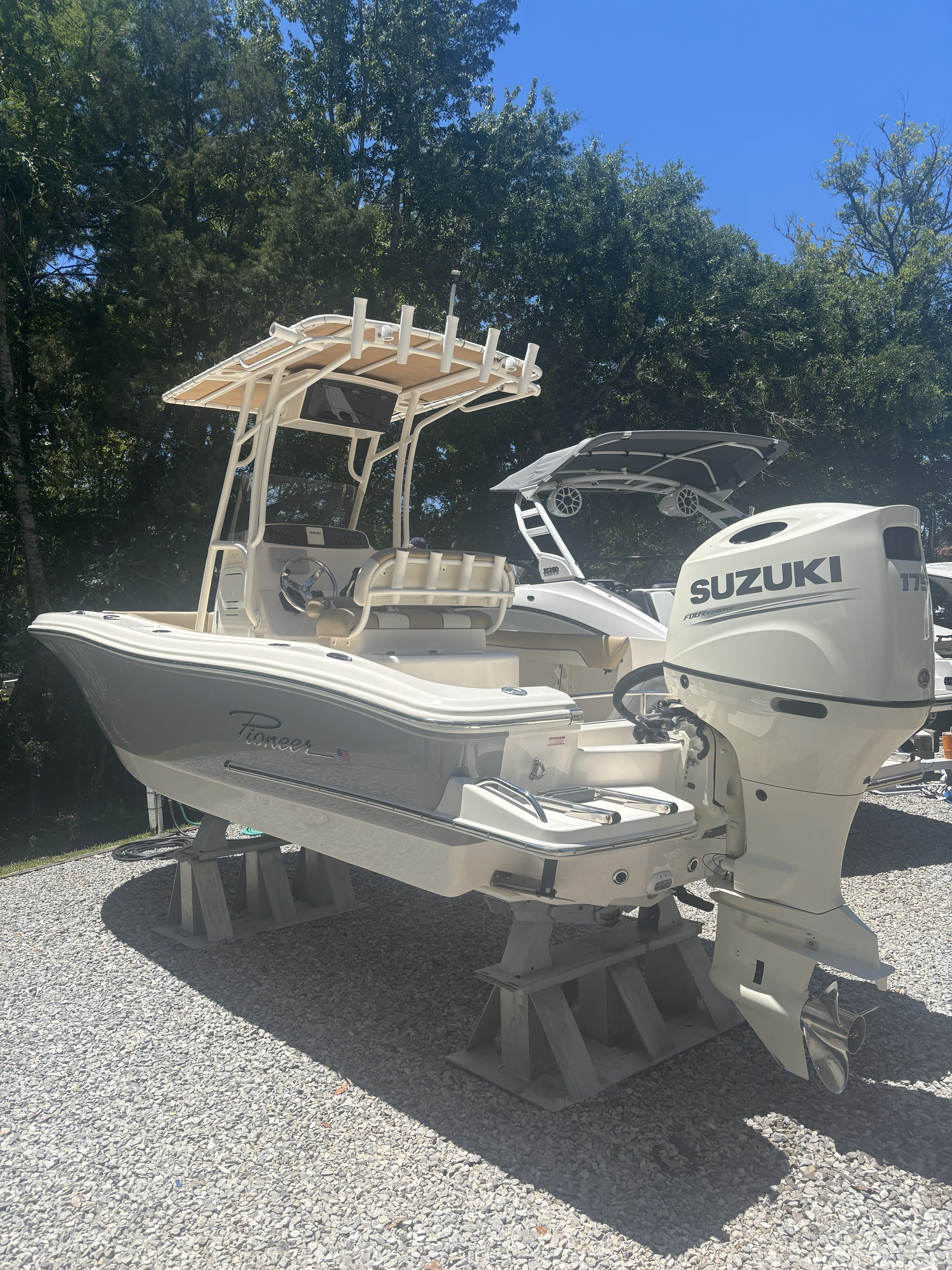 2020 Pioneer 202 Sportfish boat with Suzuki engine on stands.