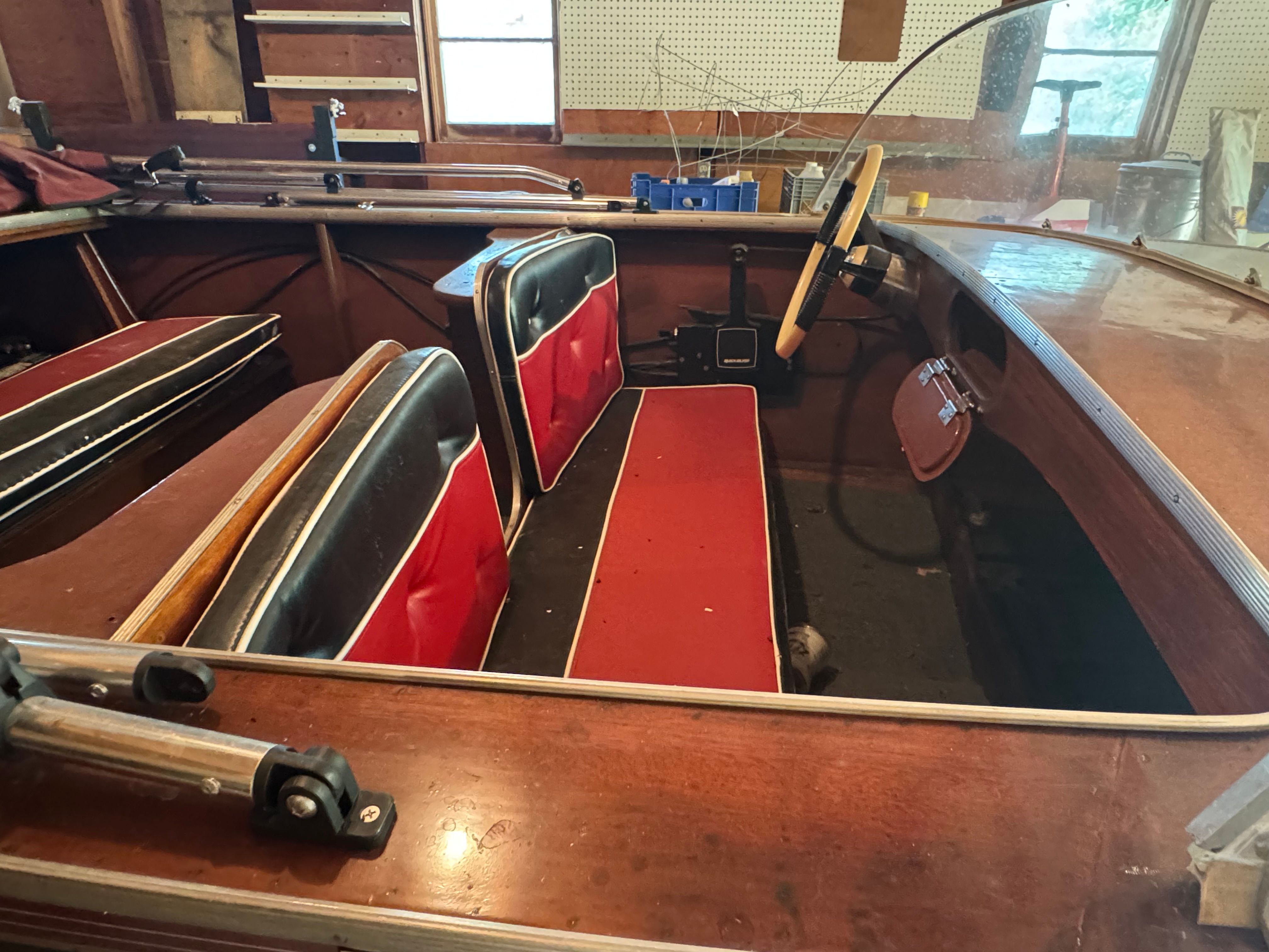 Interior of a 1958 Classic Sportcraft Runabout with red seats.