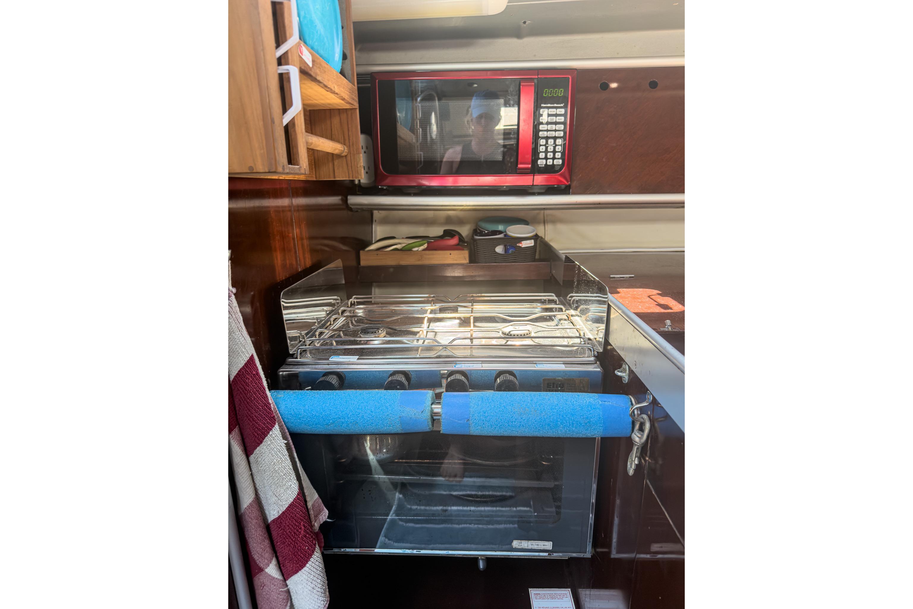 Galley kitchen in 1993 Beneteau First 38 s5 yacht with stove and microwave.
