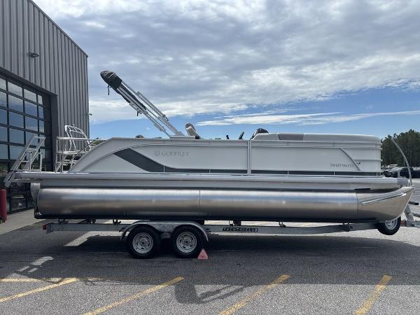 2025 Godfrey SWEETWATER 2286 SFL pontoon boat on trailer, parked outdoors.