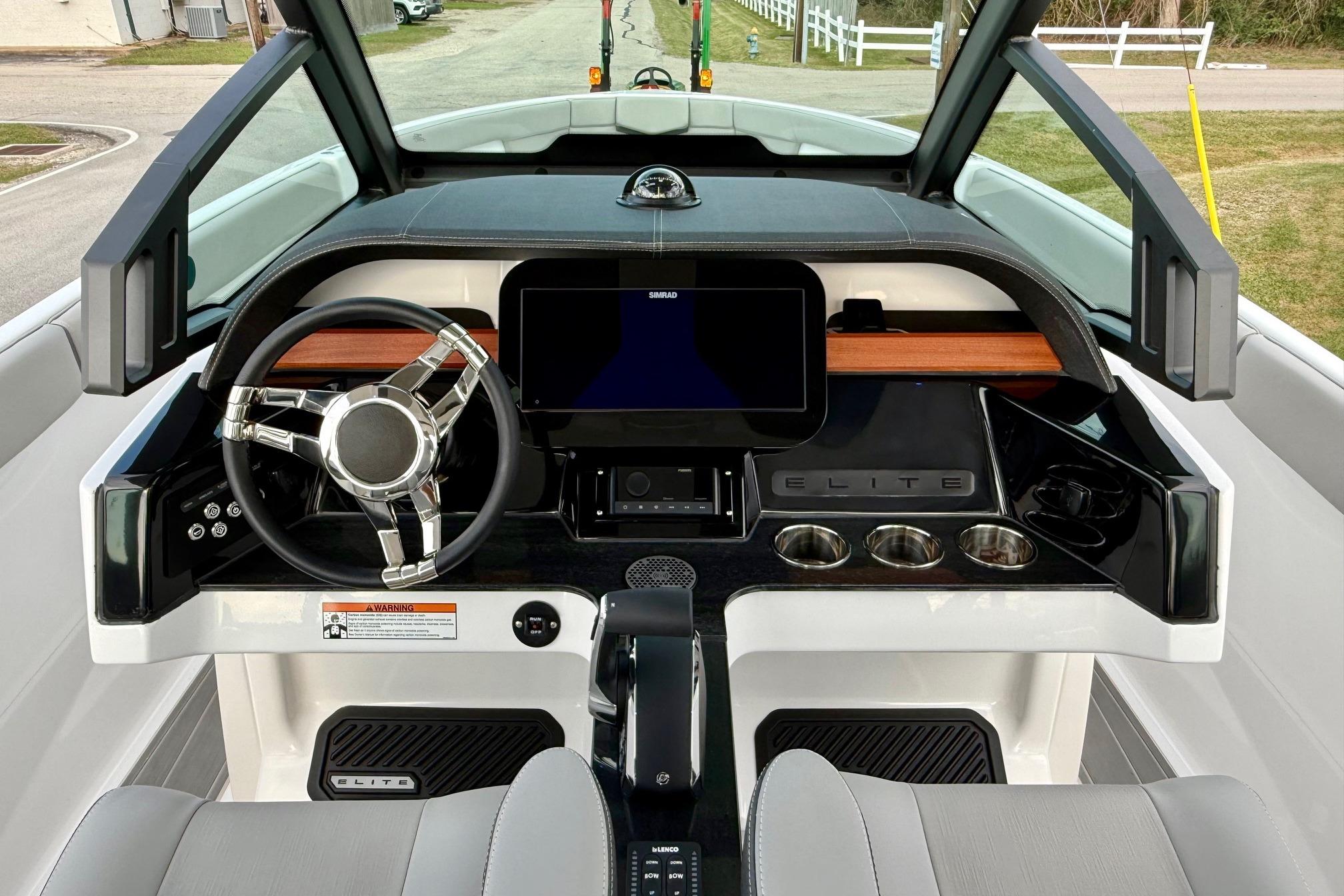 2026 Monterey Elite 25 OB boat dashboard with modern steering and digital display.
