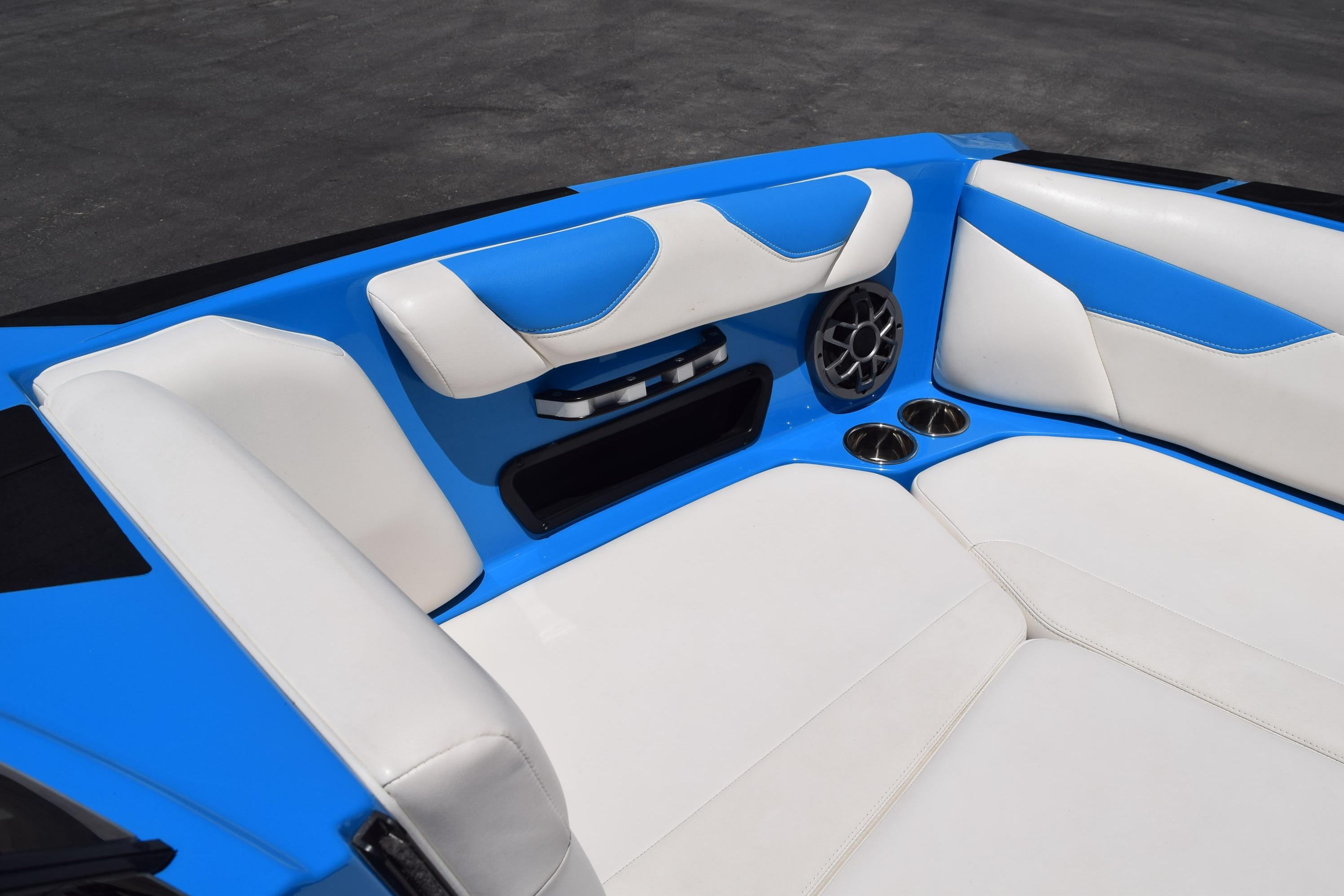 2019 Axis A22 boat interior with blue and white seating, cup holders, and speaker.