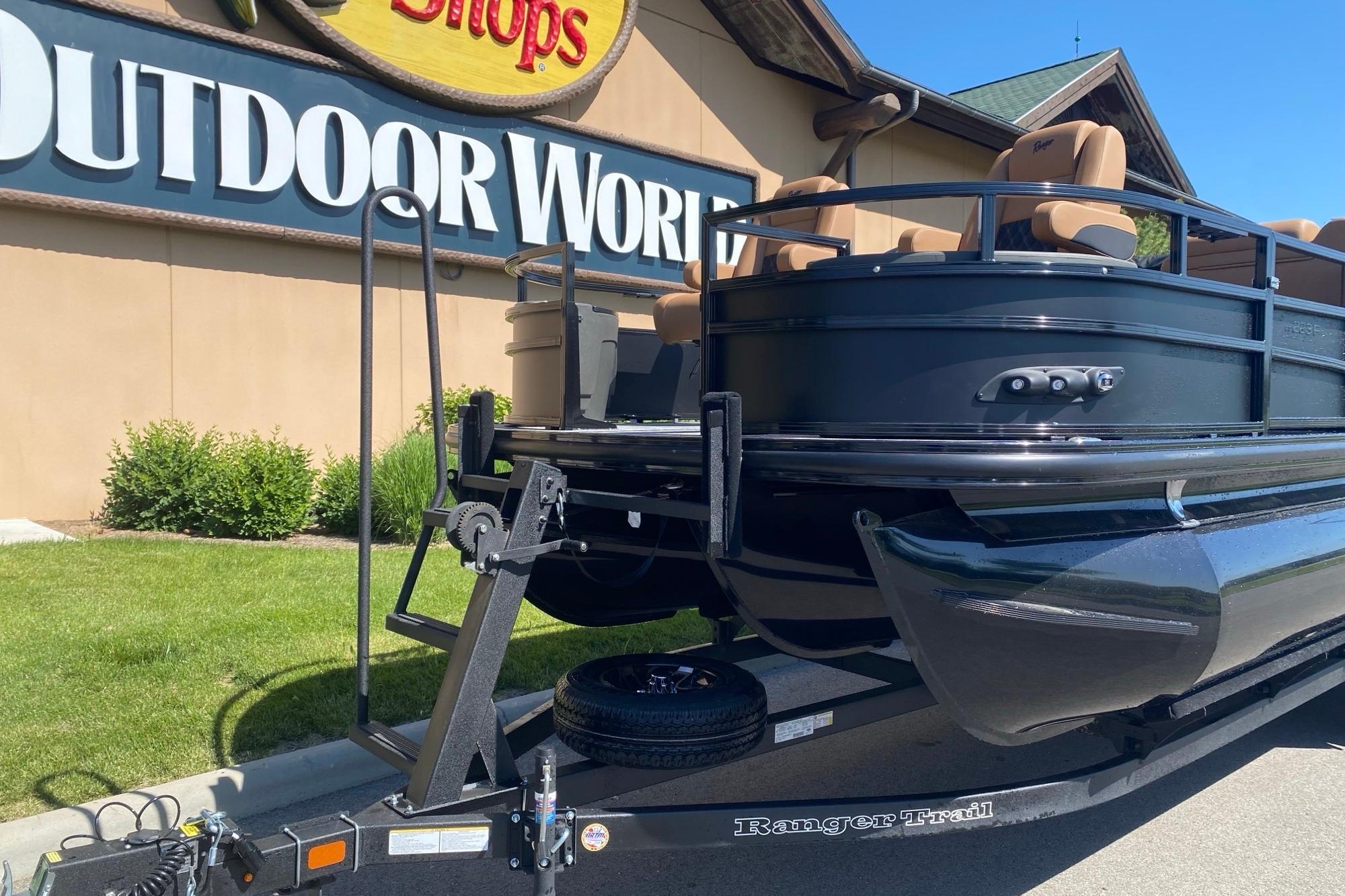 2026 Ranger 223F pontoon boat on trailer at Outdoor World store.