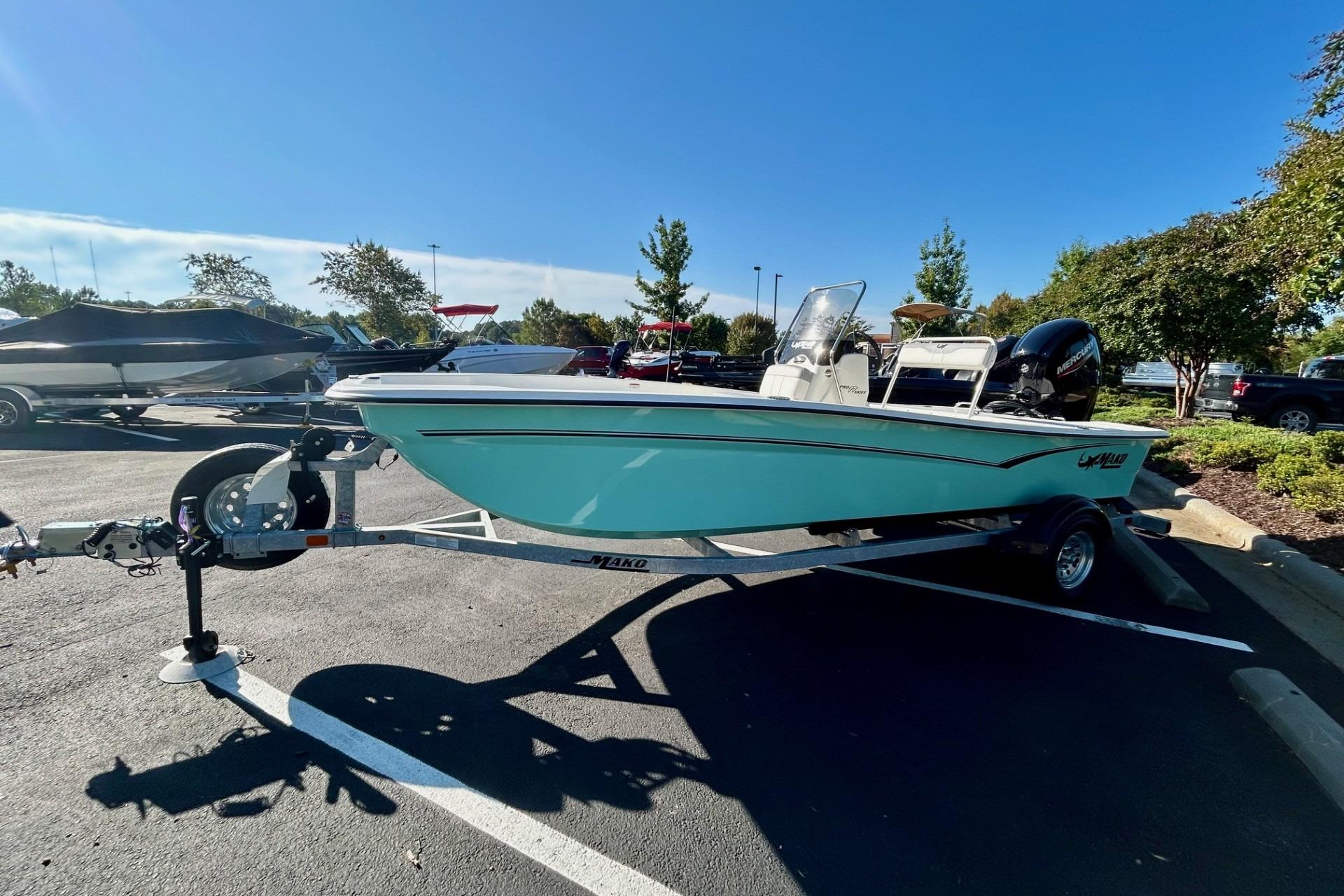 2026 Mako Pro Skiff 17 CC boat on trailer in parking lot, sunny day.