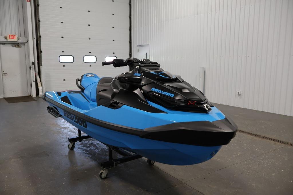 2026 Sea-Doo RXT-X 325 jet ski in a garage, showcasing sleek blue and black design.