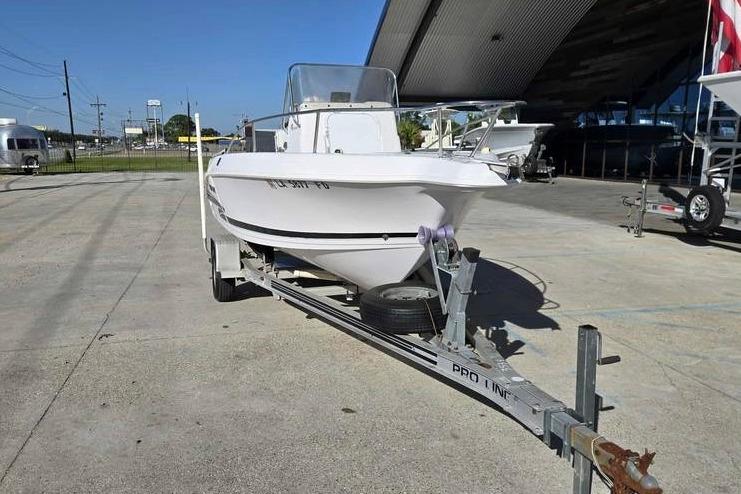 2001 Pro-Line 19 Sport boat on trailer in outdoor storage area.