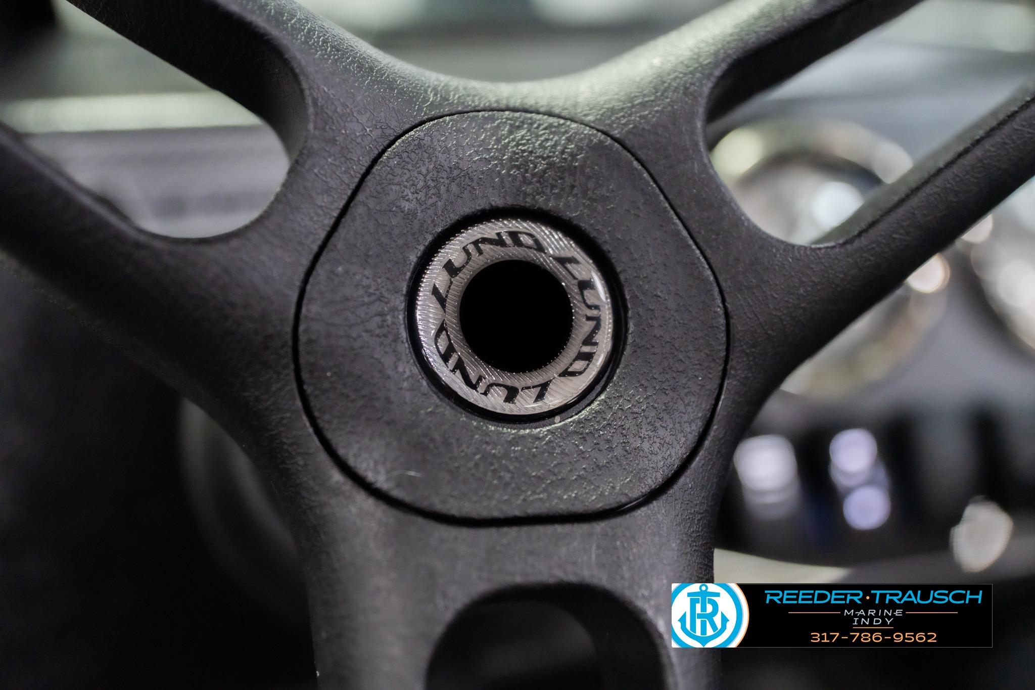 Close-up of 2026 Lund 1700 Explorer Sport steering wheel with logo detail.