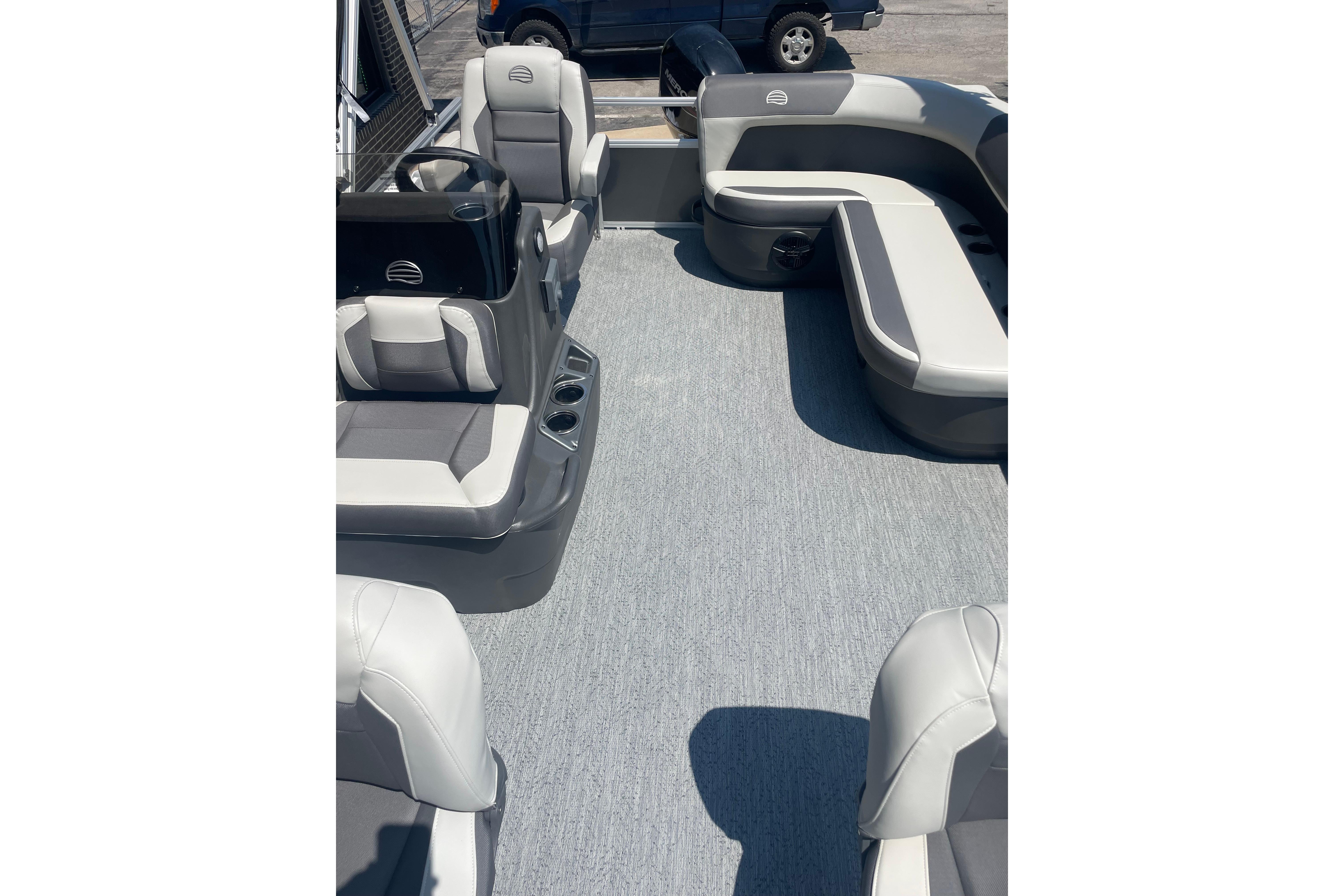 2026 Sun Tracker Bass Buggy 16 XL Select pontoon boat interior with gray seating and carpet.