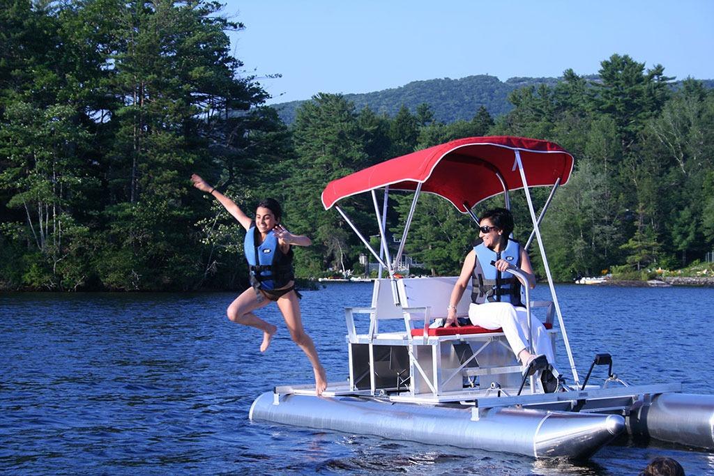 Two people enjoying a 2026 Aqua Cycle 2 on a scenic lake.