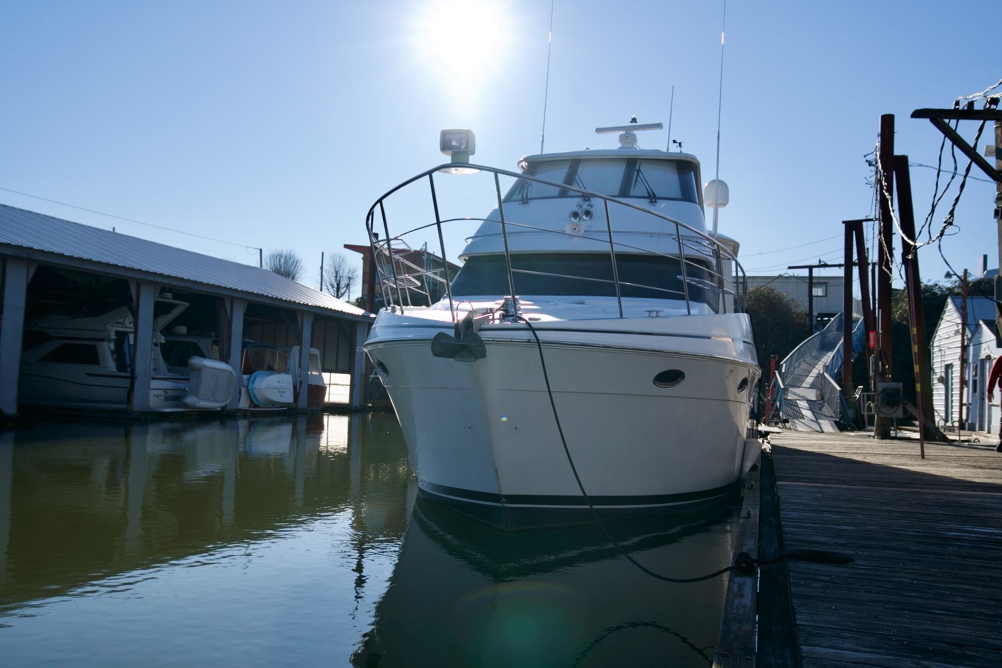 2000 Carver 506 Motor Yacht docked in sunny marina setting.