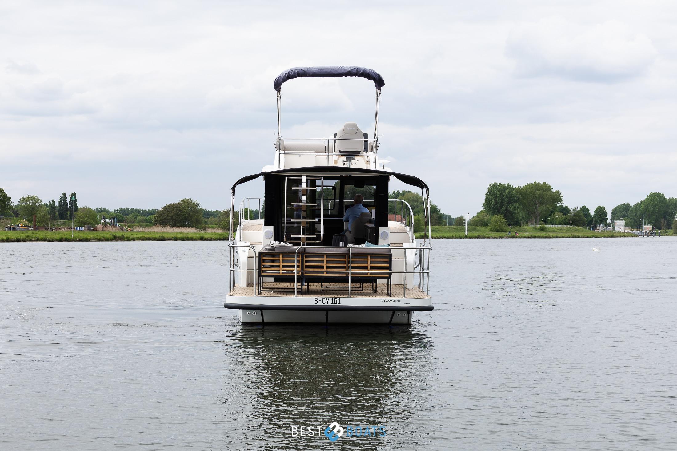 2023 Cobra Yachts Futura 36 Premium Fly on a serene river, rear view.
